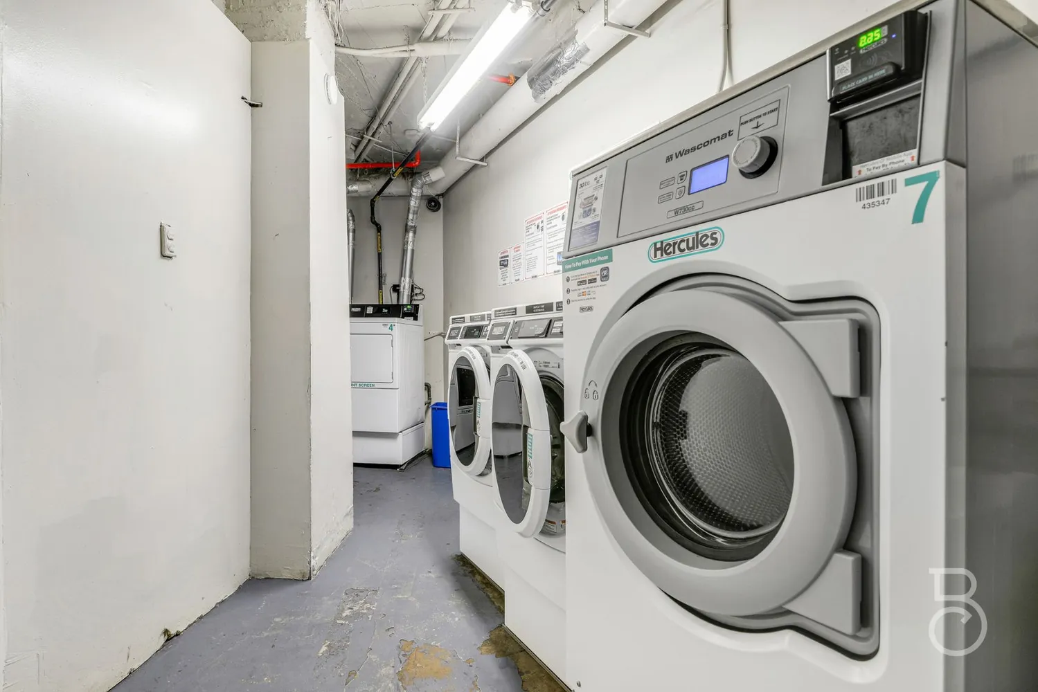 a front view of a multi story building with yard