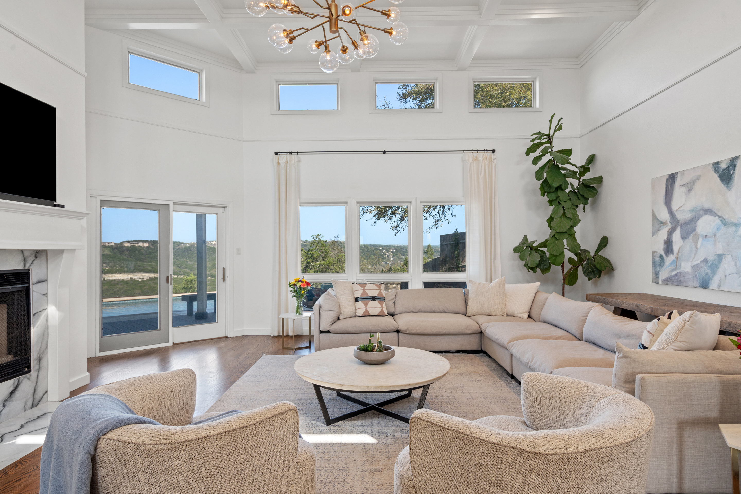 5319 Backtrail Drive Austin, TX 78731 - Photo 12 of 35 a living room with furniture a flat screen tv and a large window