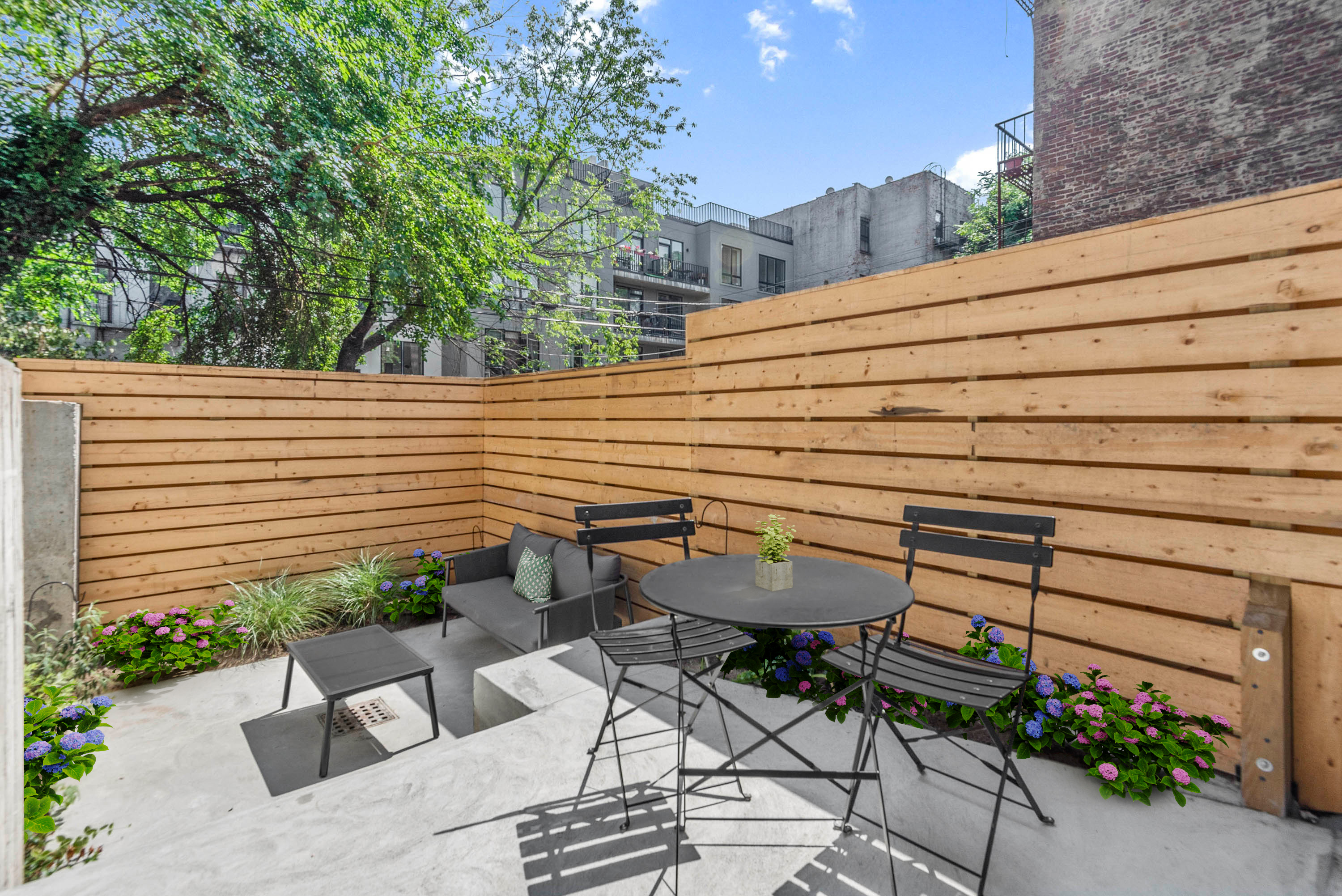 702 Hancock Street, Unit 1A Brooklyn, NY 11233 - Photo 2 of 13 a backyard of a house with outdoor seating