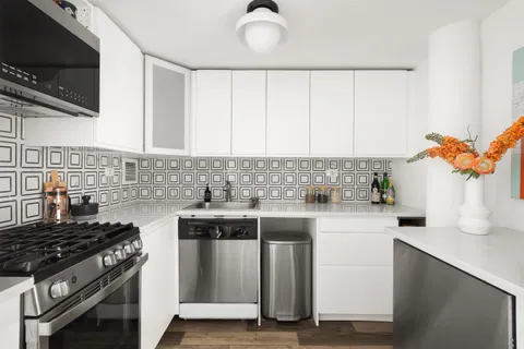 a kitchen with a stove a sink and a microwave