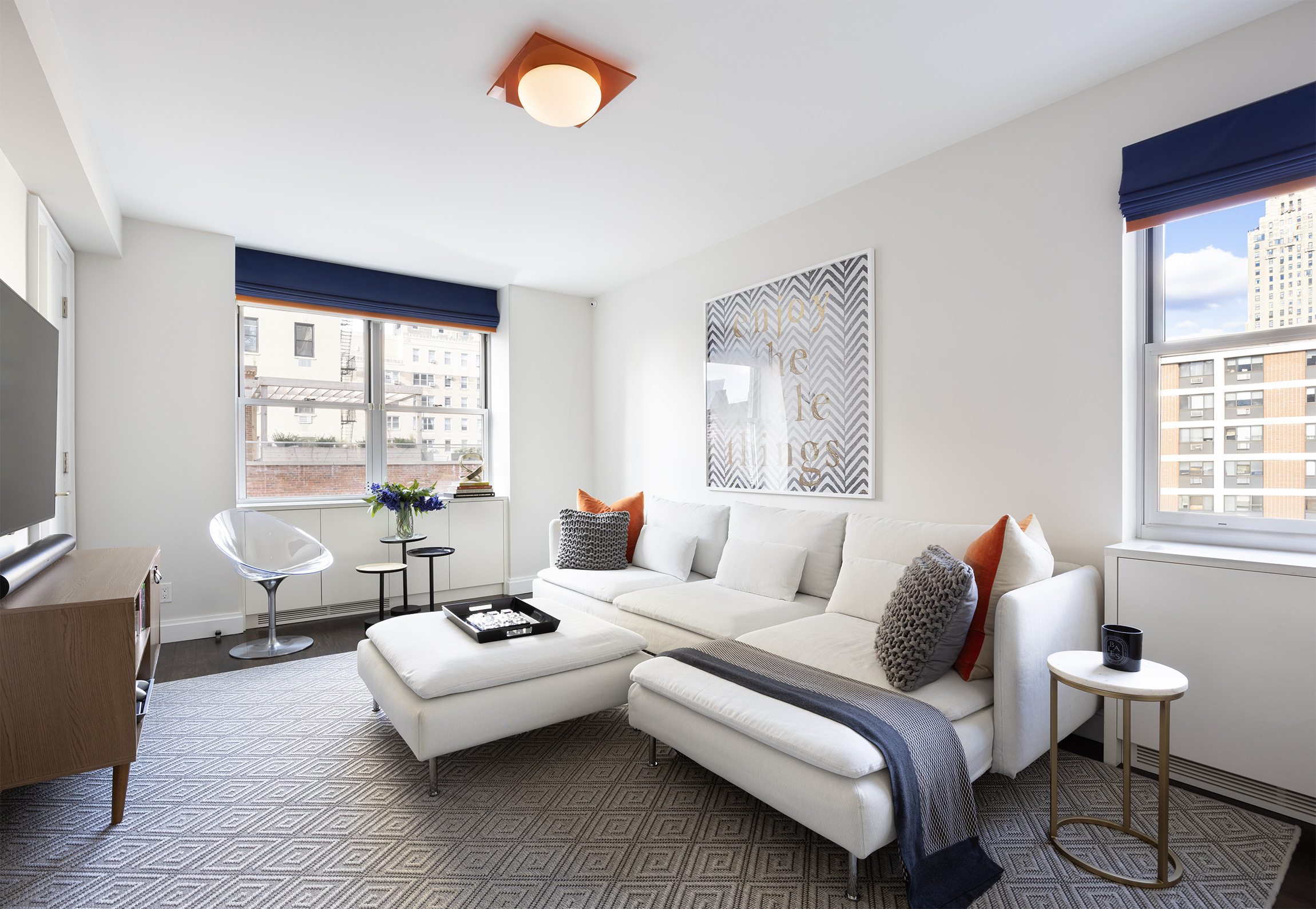 45 East 72nd Street, Unit 9BC Manhattan, NY 10021 - Photo 14 of 16 a living room with furniture and a large window
