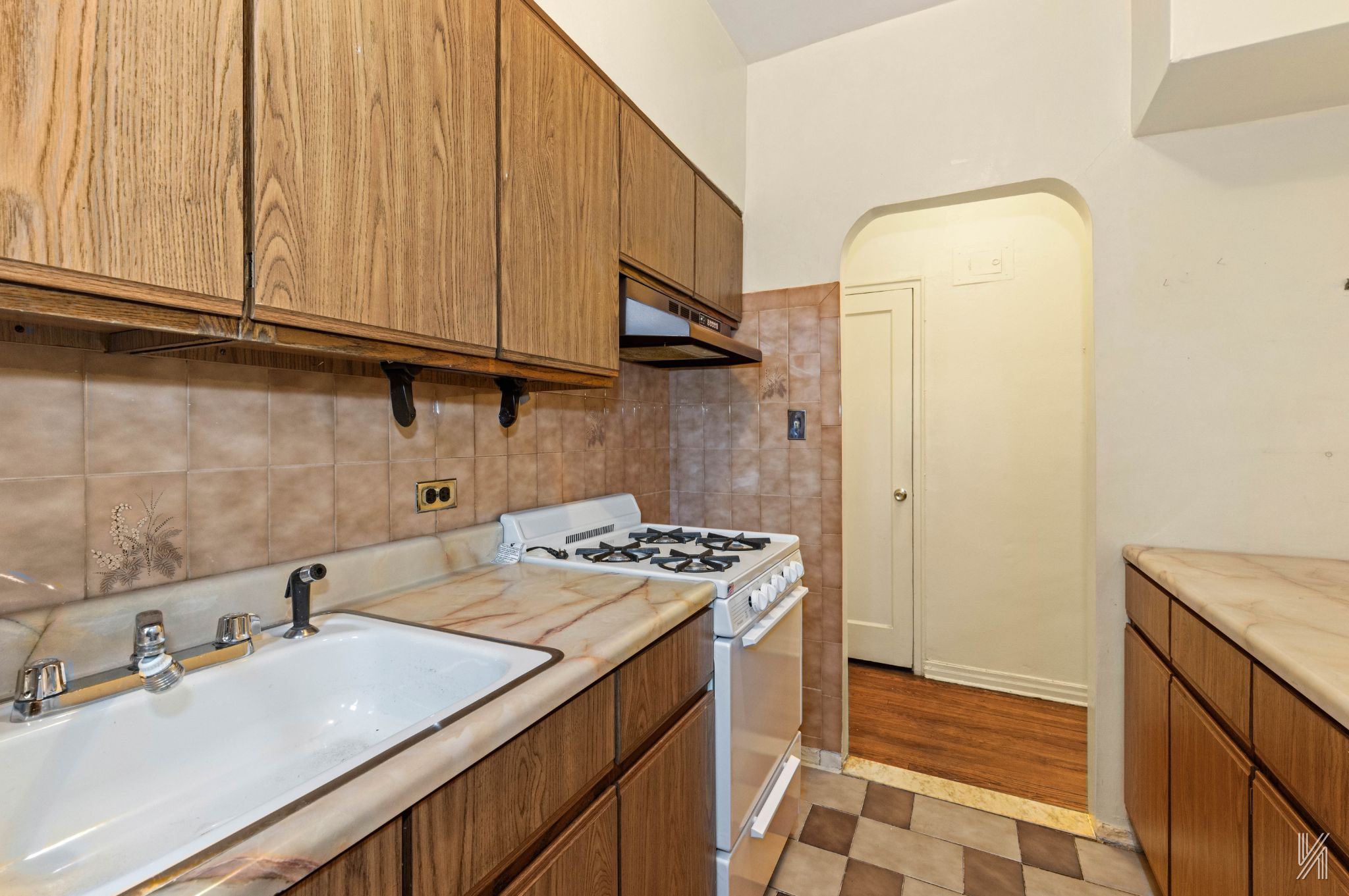 22-60 79th Street, Unit 1A Queens, NY 11370 - Photo 7 of 17 a kitchen with stainless steel appliances granite countertop a sink stove and cabinets