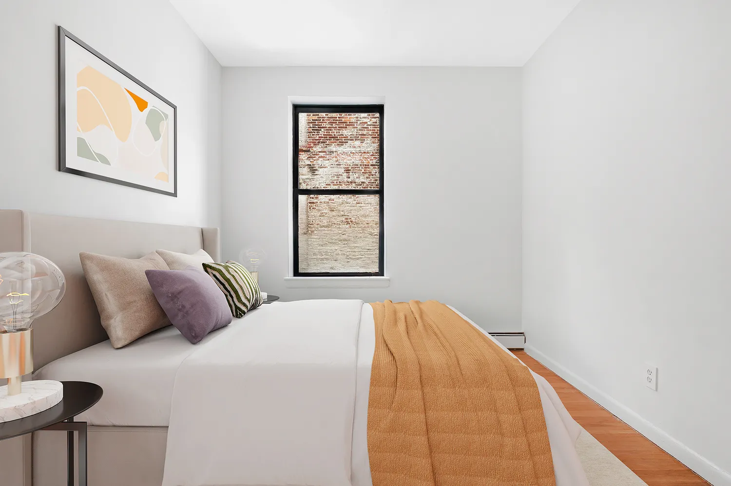 a bed sitting in a bedroom next to a window