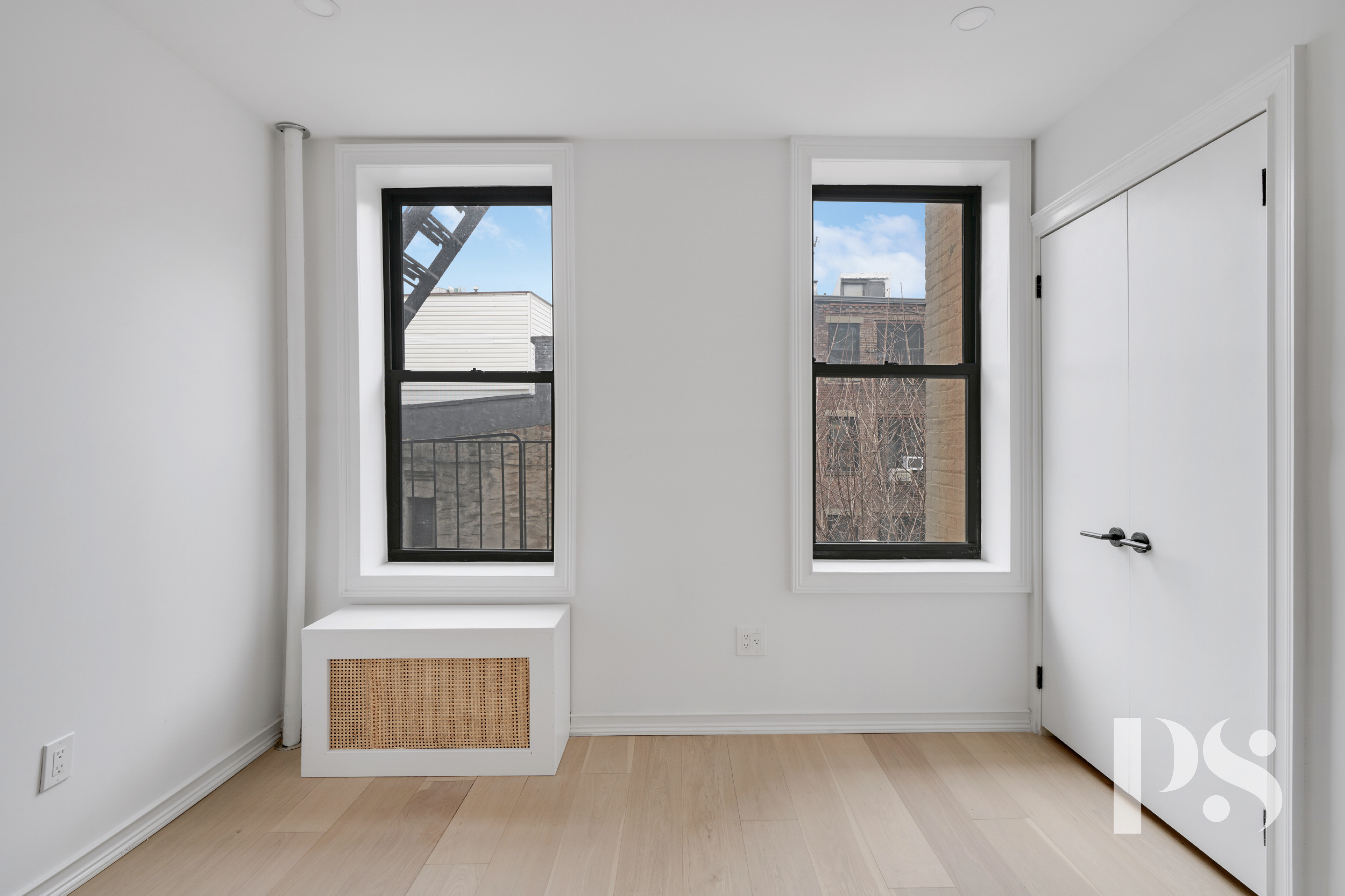 51 Jane Street, Unit 16 Manhattan, NY 10014 - Photo 3 of 6 an empty room with windows and closet