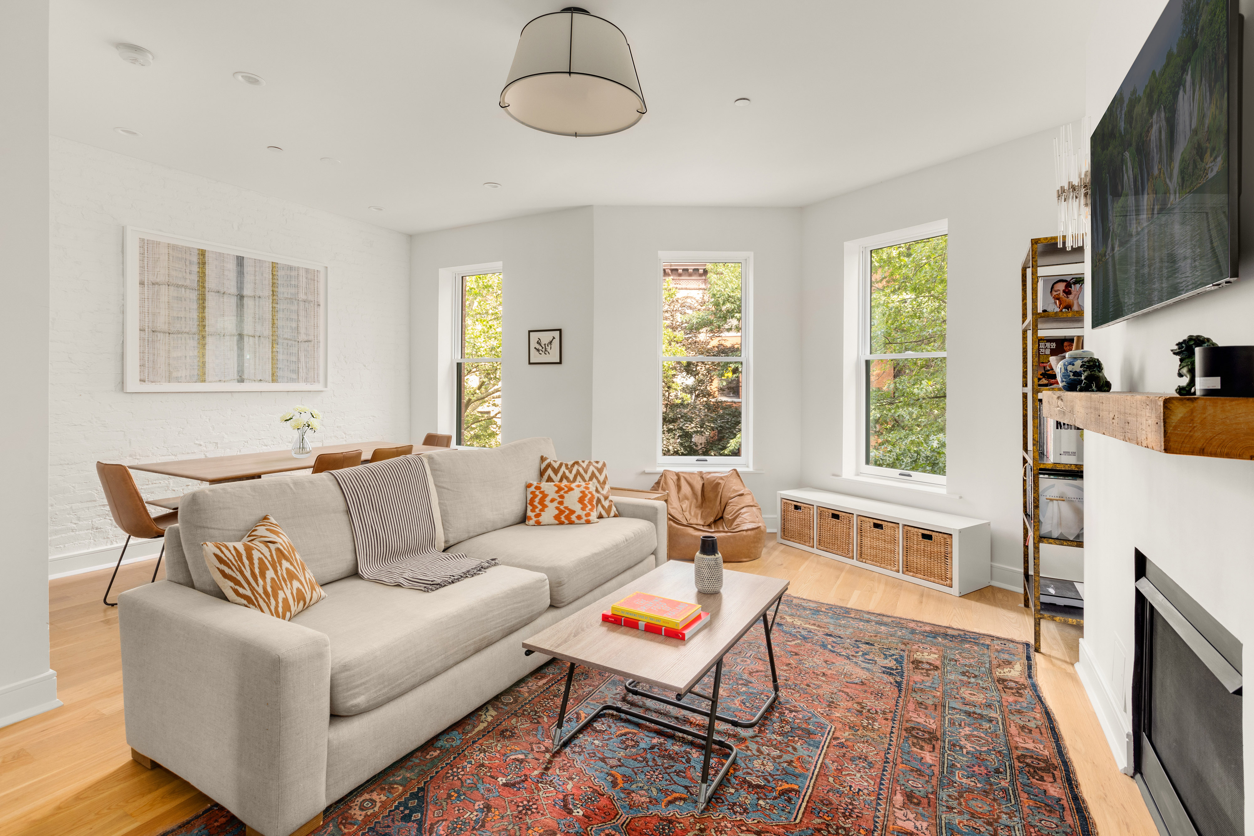 352 6th Avenue, Unit 3 Brooklyn, NY 11215 - Photo 3 of 14 a living room with furniture a flat screen tv and a fireplace