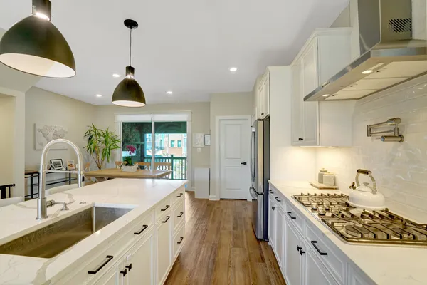a kitchen with stainless steel appliances granite countertop a sink and a stove