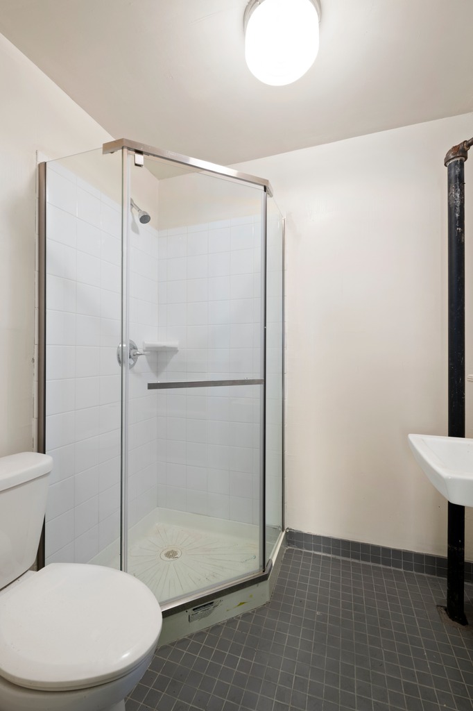 151 1st Avenue, Unit 3F Manhattan, NY 10003 - Photo 7 of 9 a bathroom with a toilet and a shower