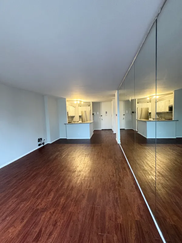 a view of a room with wooden floor