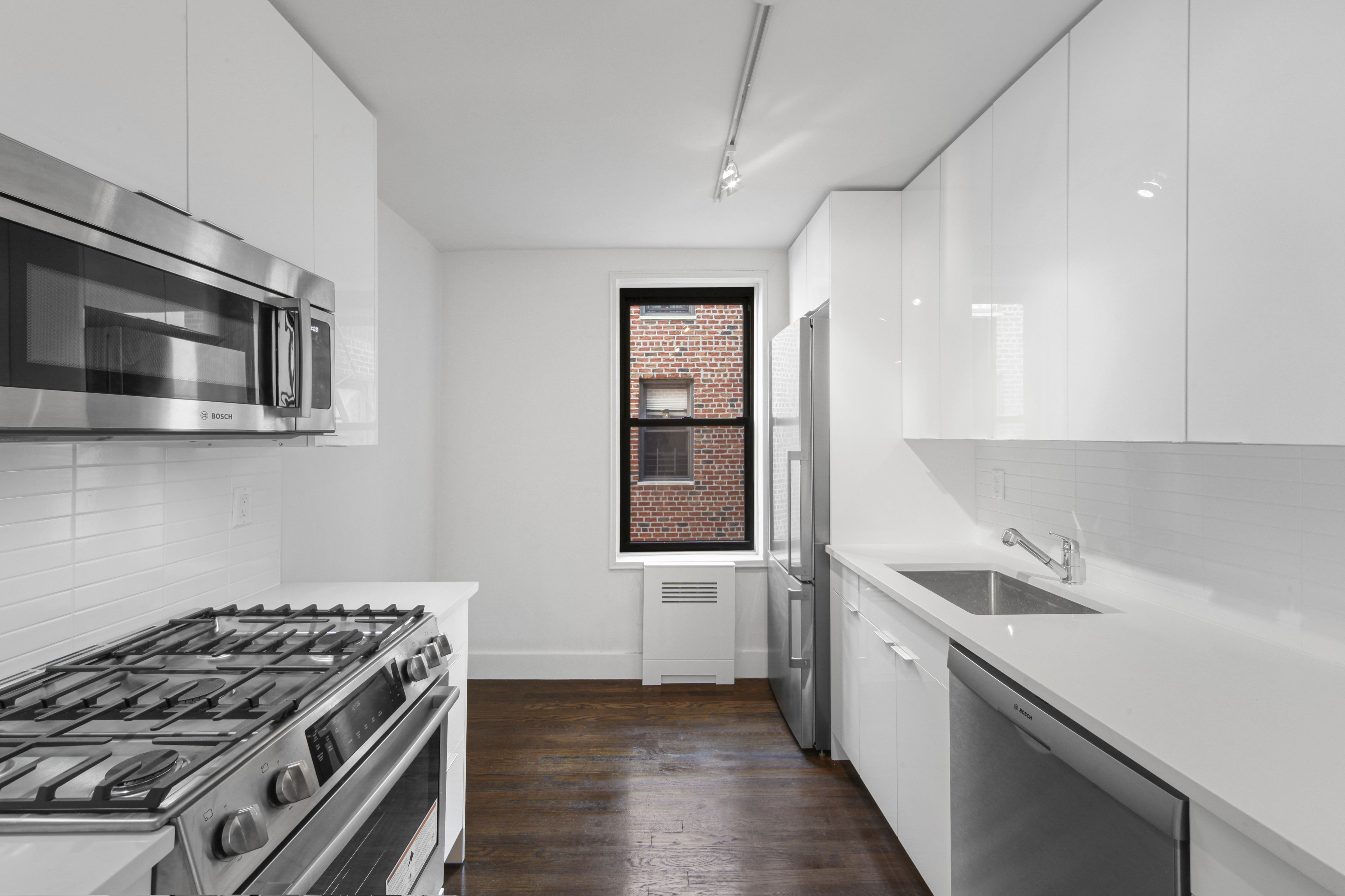 9511 Shore Road, Unit 505 Brooklyn, NY 11209 - Photo 8 of 18 a kitchen with a stove and a sink