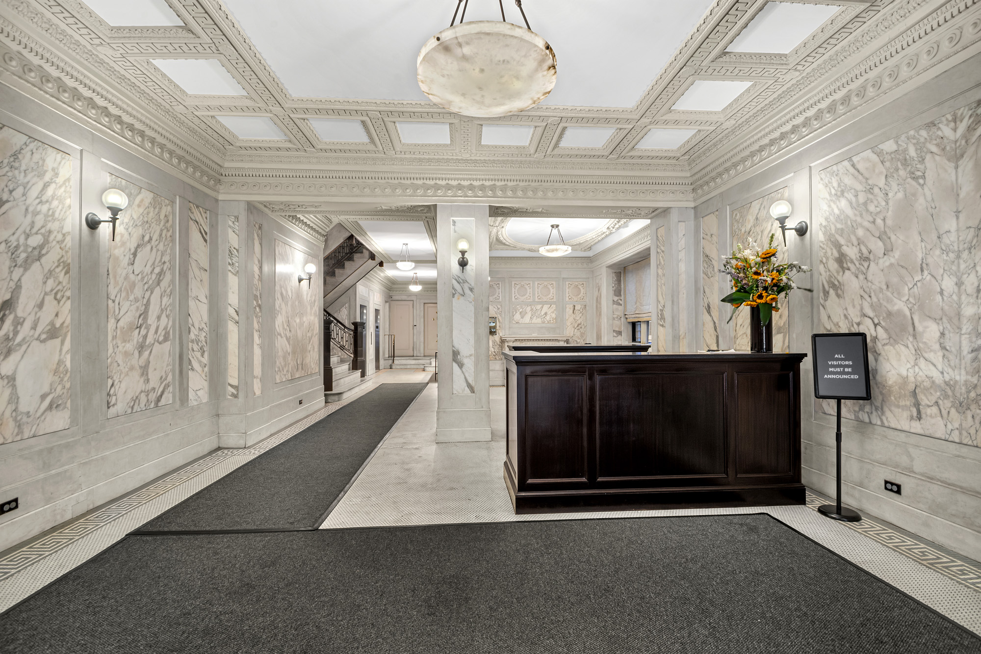 817 West End Avenue, Unit 6B Manhattan, NY 10025 - Photo 3 of 10 a view of a hallway with a fireplace and a chandelier