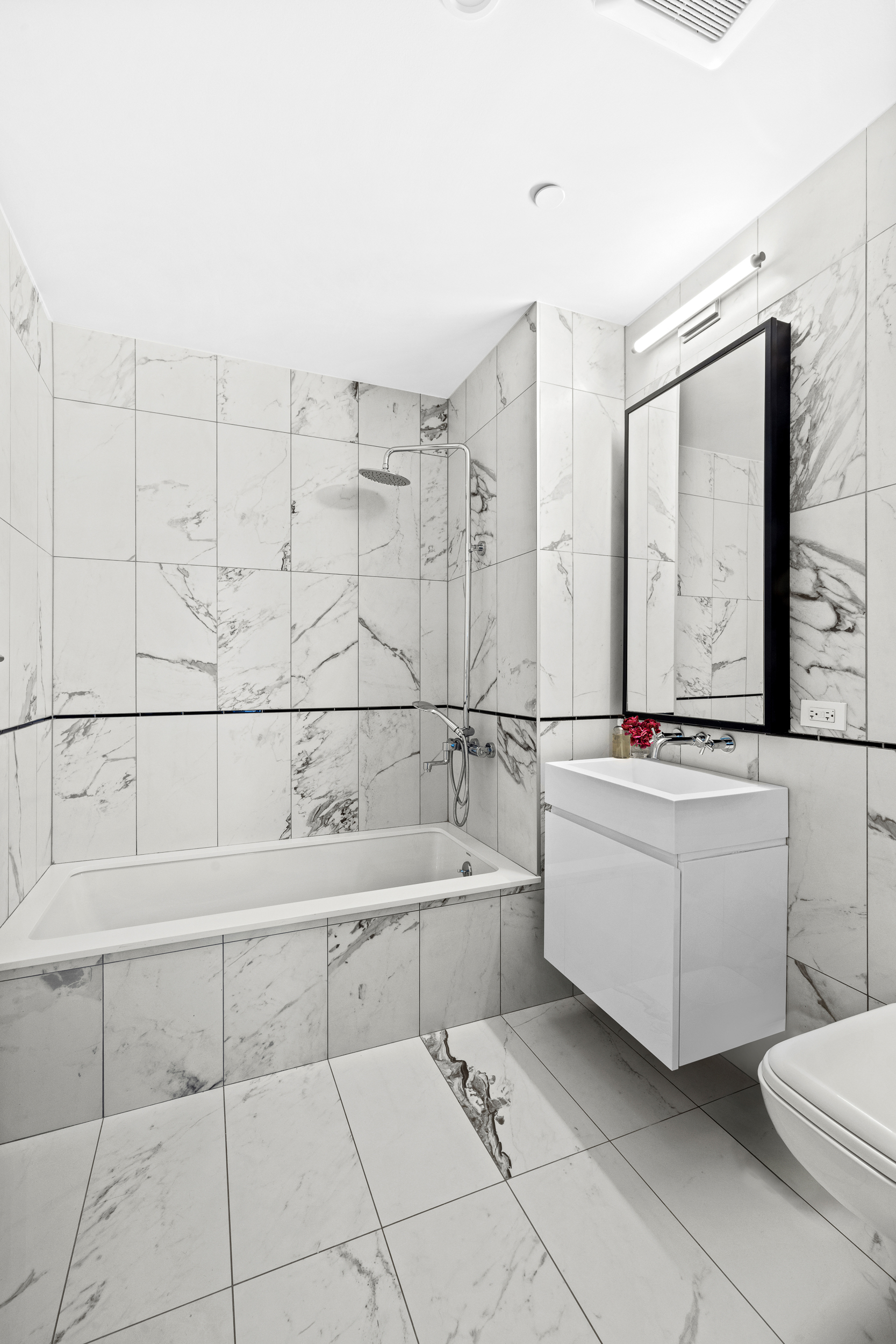 427 East 90th Street, Unit 5A Manhattan, NY 10128 - Photo 8 of 13 a bathroom with a bathtub sink and toilet