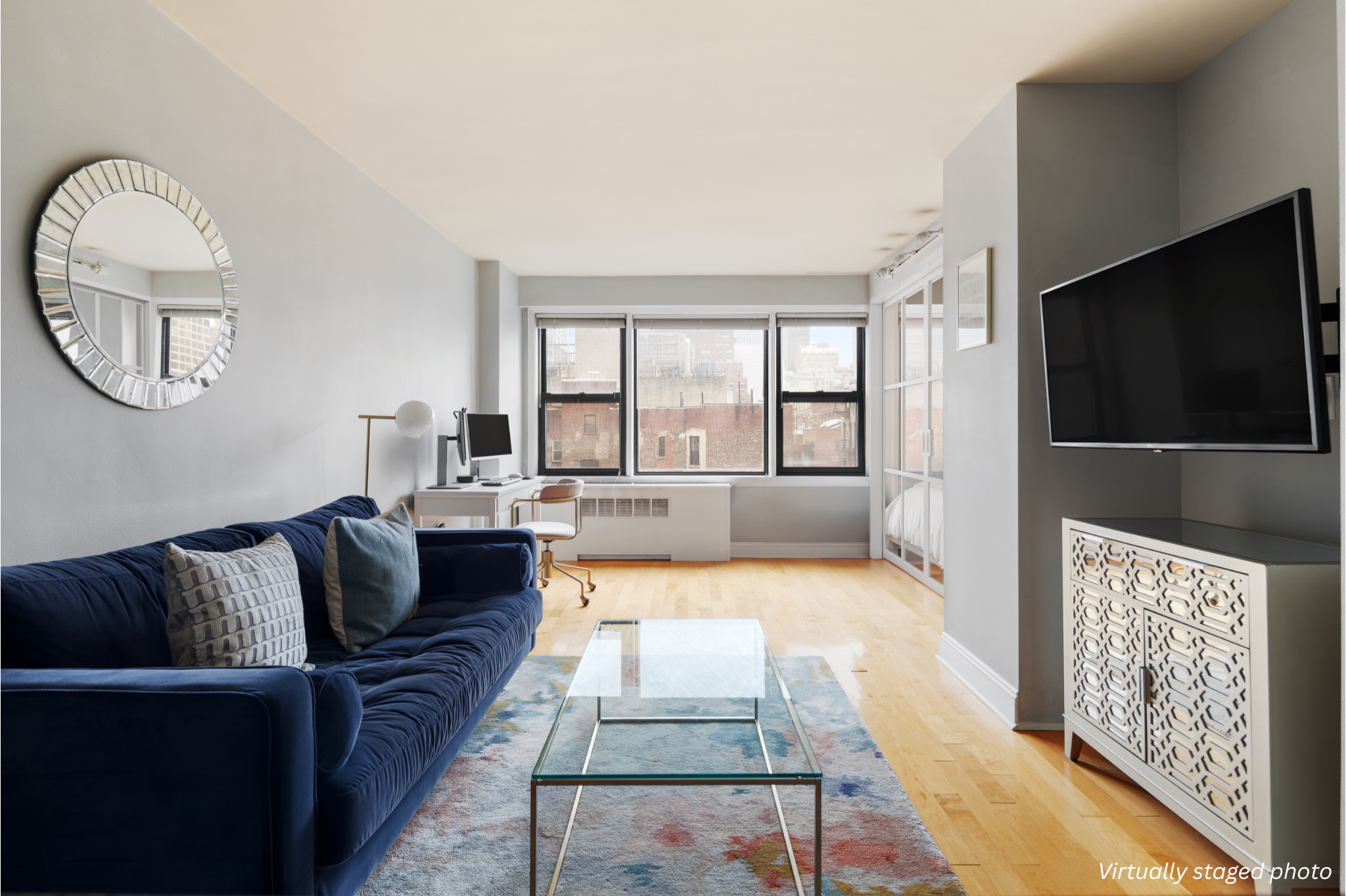 245 East 24th Street, Unit 9B Manhattan, NY 10010 - Photo 1 of 7 a living room with furniture and a flat screen tv