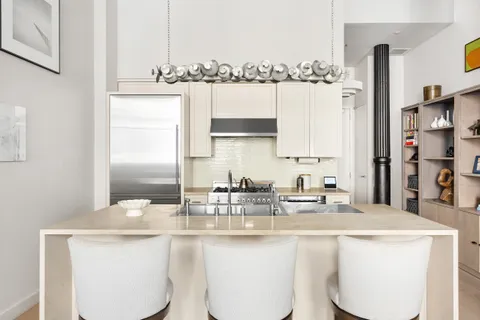 a kitchen with stainless steel appliances a sink and a counter space