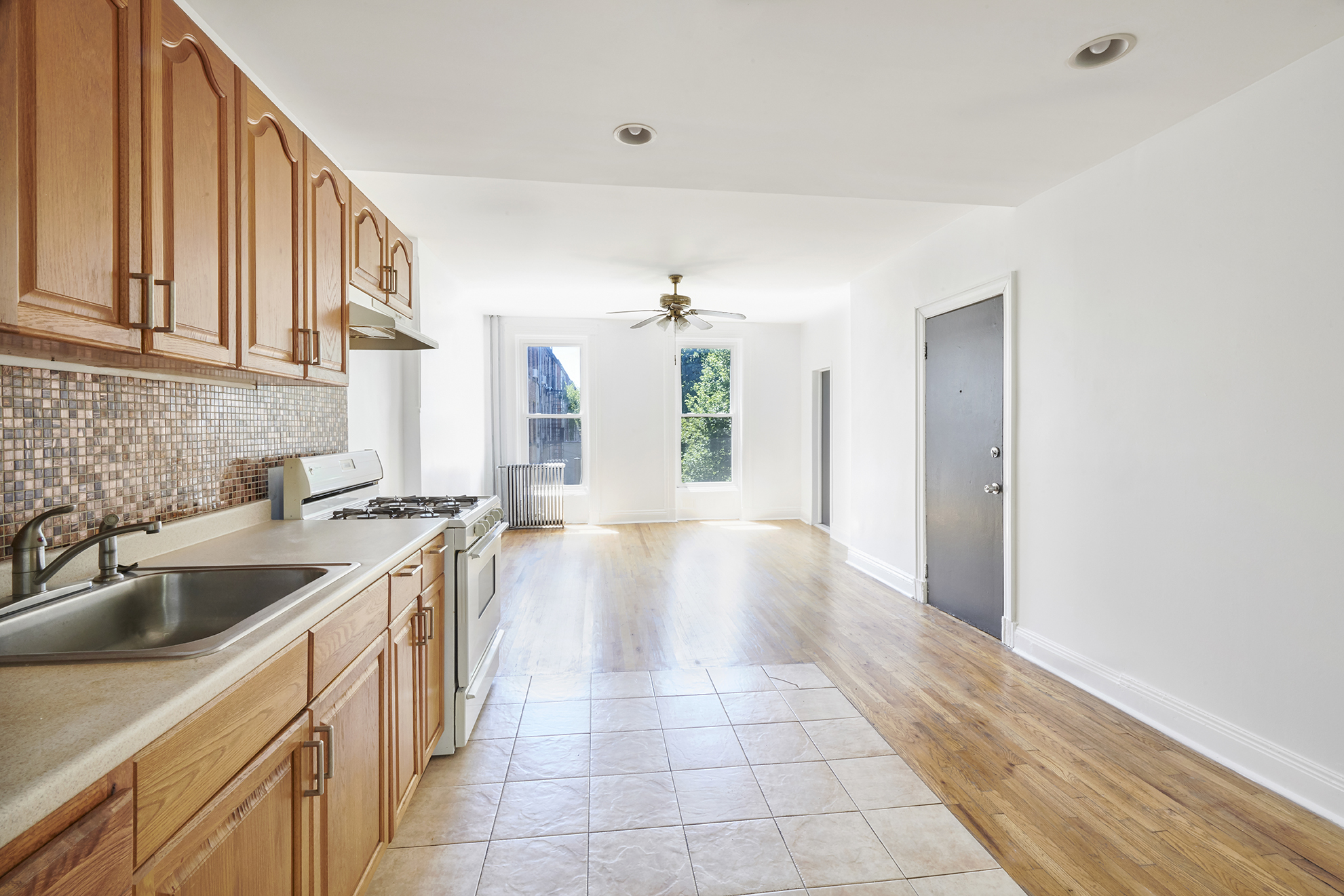 276 Stuyvesant Avenue, Unit 2 Brooklyn, NY 11221 - Photo 9 of 11 a kitchen with a sink cabinets and window