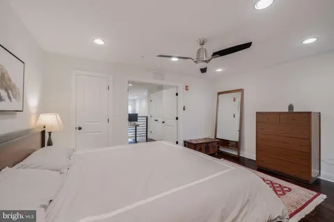 a bedroom with a large bed and a dresser