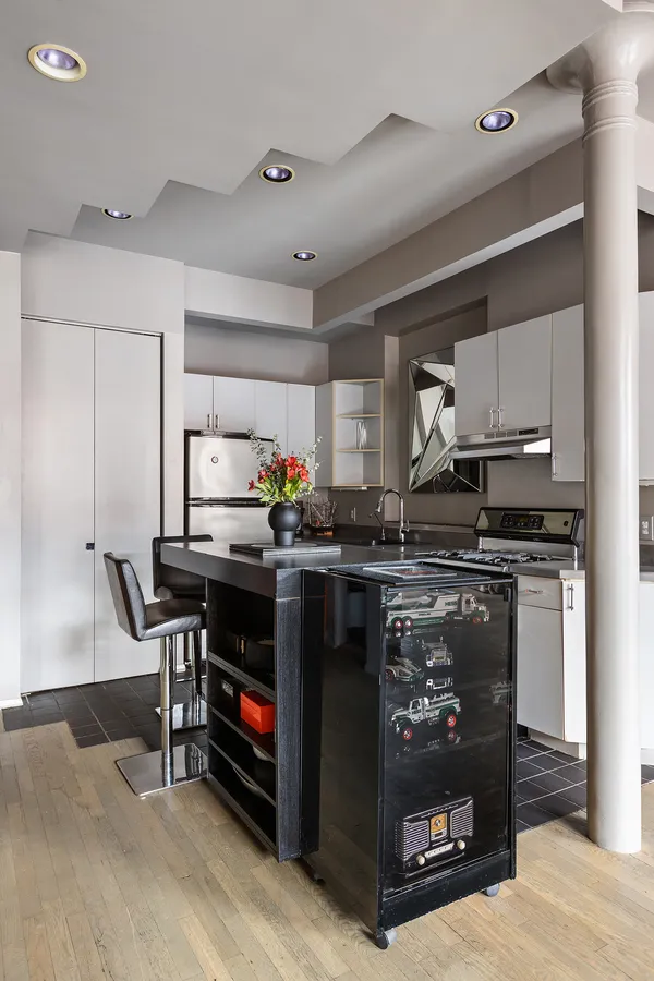 a kitchen with stainless steel appliances granite countertop a stove and a refrigerator