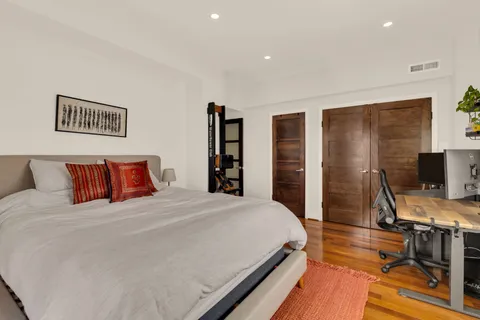 a view of a balcony with wooden benches