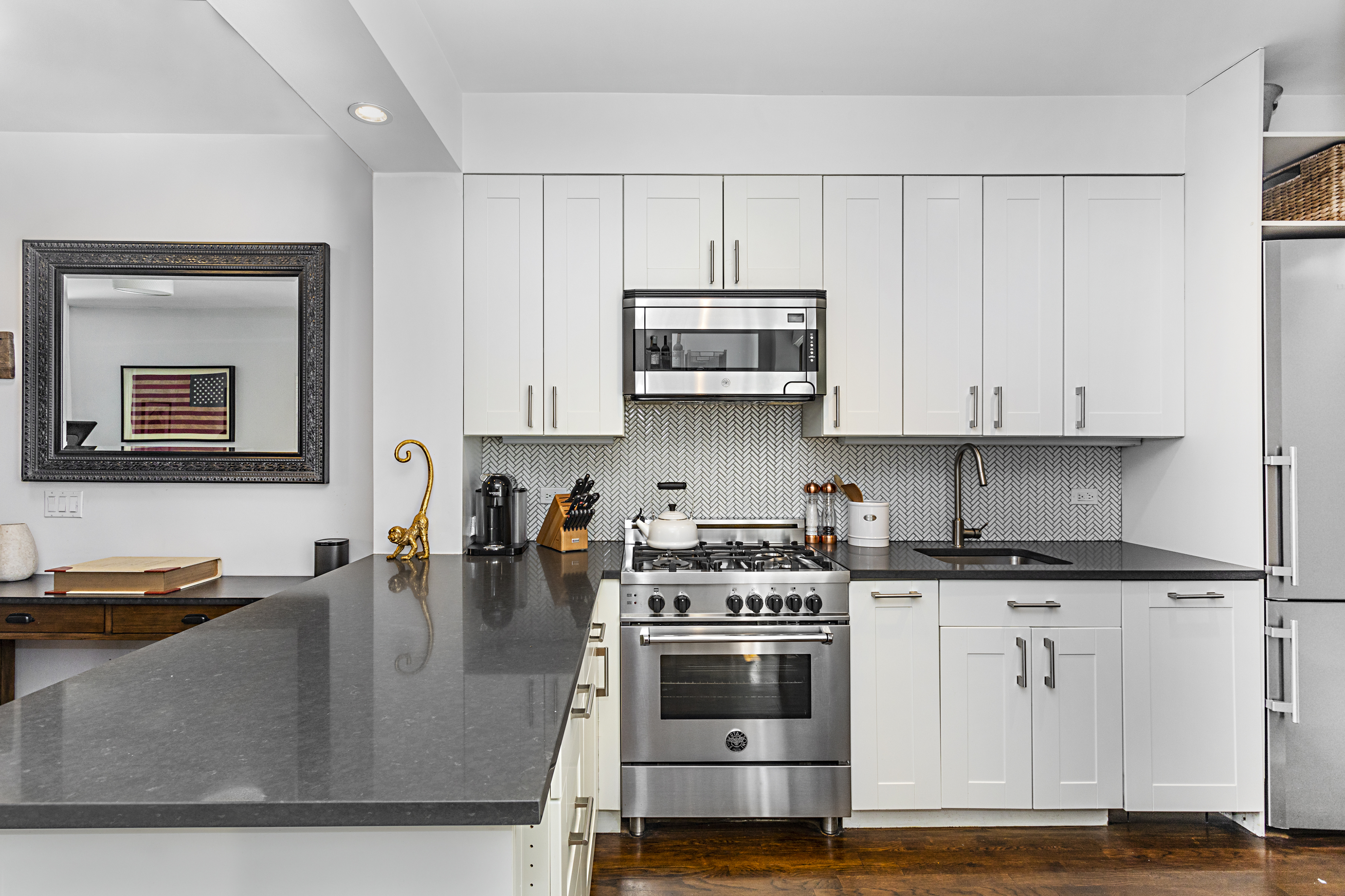 236 East 6th Street, Unit 2W Manhattan, NY 10003 - Photo 3 of 7 a kitchen with stainless steel appliances granite countertop a stove a sink and white cabinets