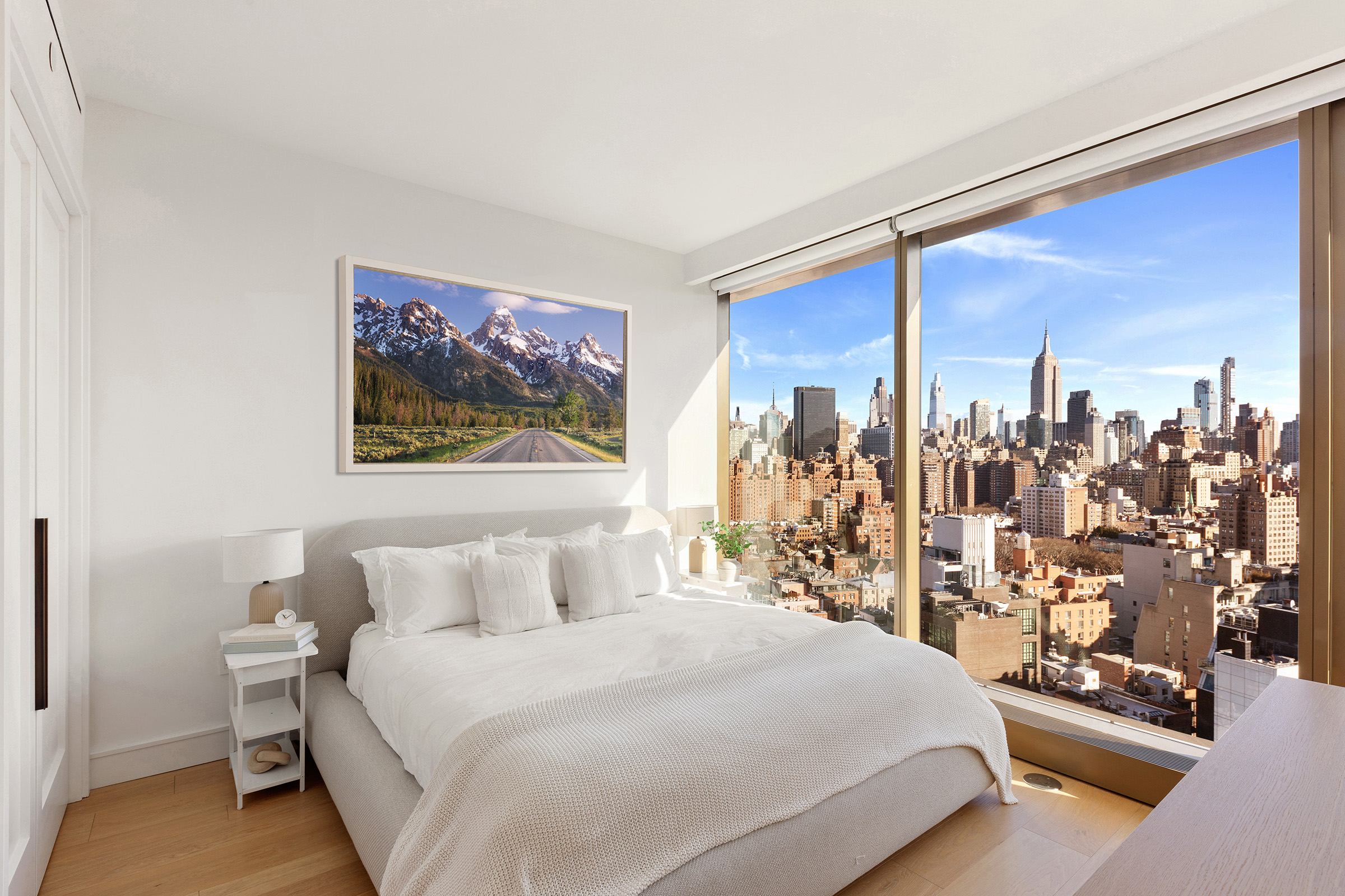 500 West 18th Street, Unit EAST 19E Manhattan, NY 10011 - Photo 9 of 18 a bedroom with a large bed and a chandelier