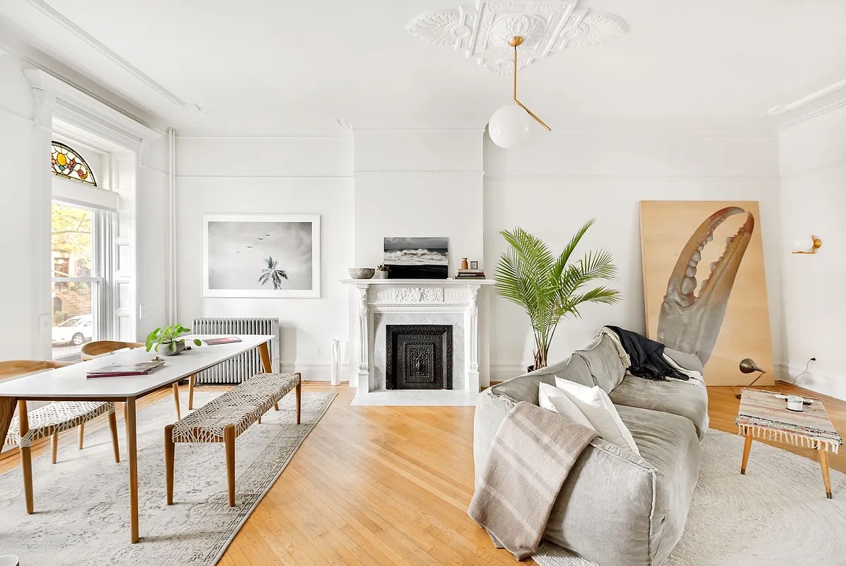611 Macon Street Brooklyn, NY 11233 - Photo 4 of 12 a living room with furniture mirror and fireplace