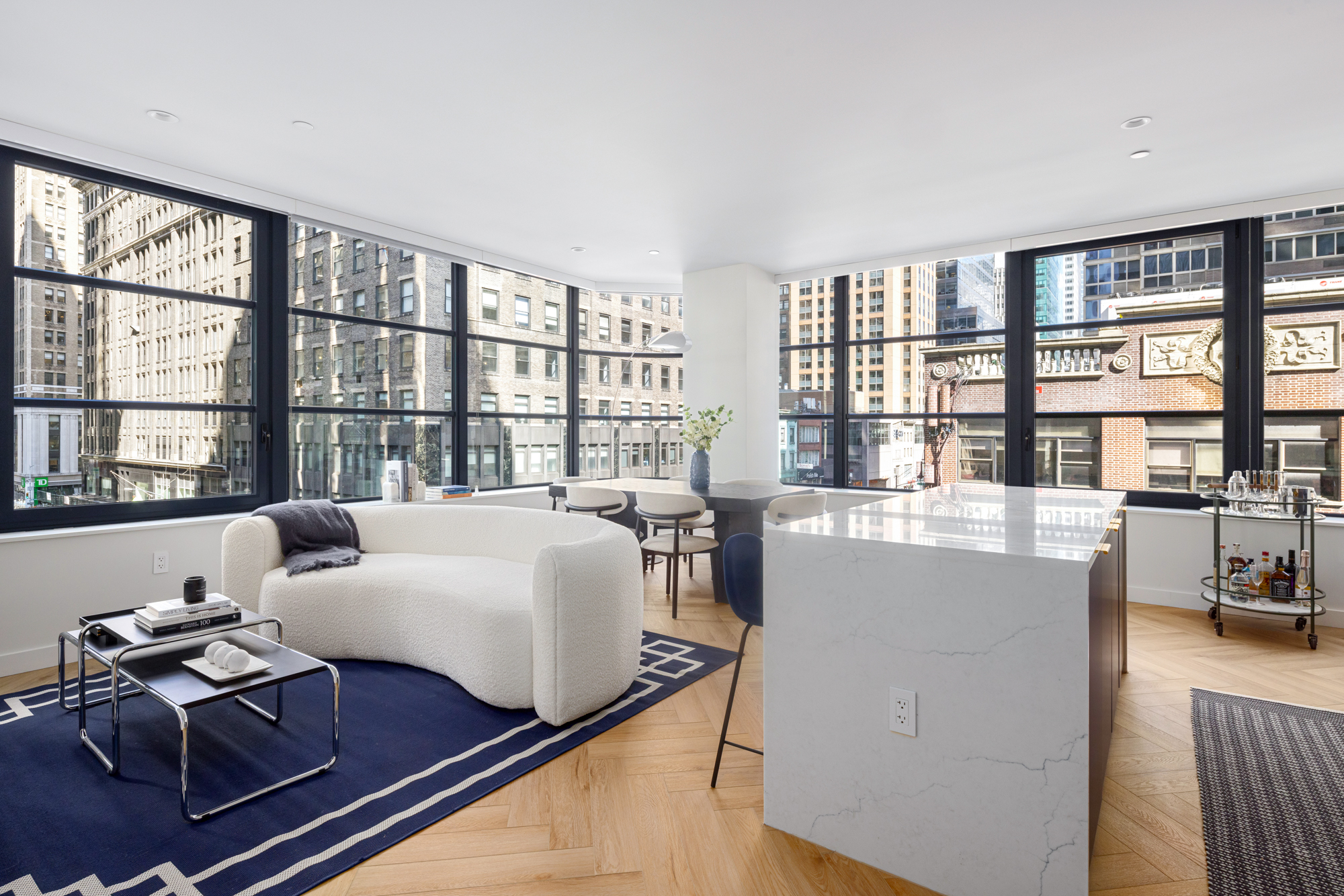 980 6th Avenue, Unit 416 Manhattan, NY 10018 - Photo 2 of 22 a living room with furniture and a floor to ceiling window