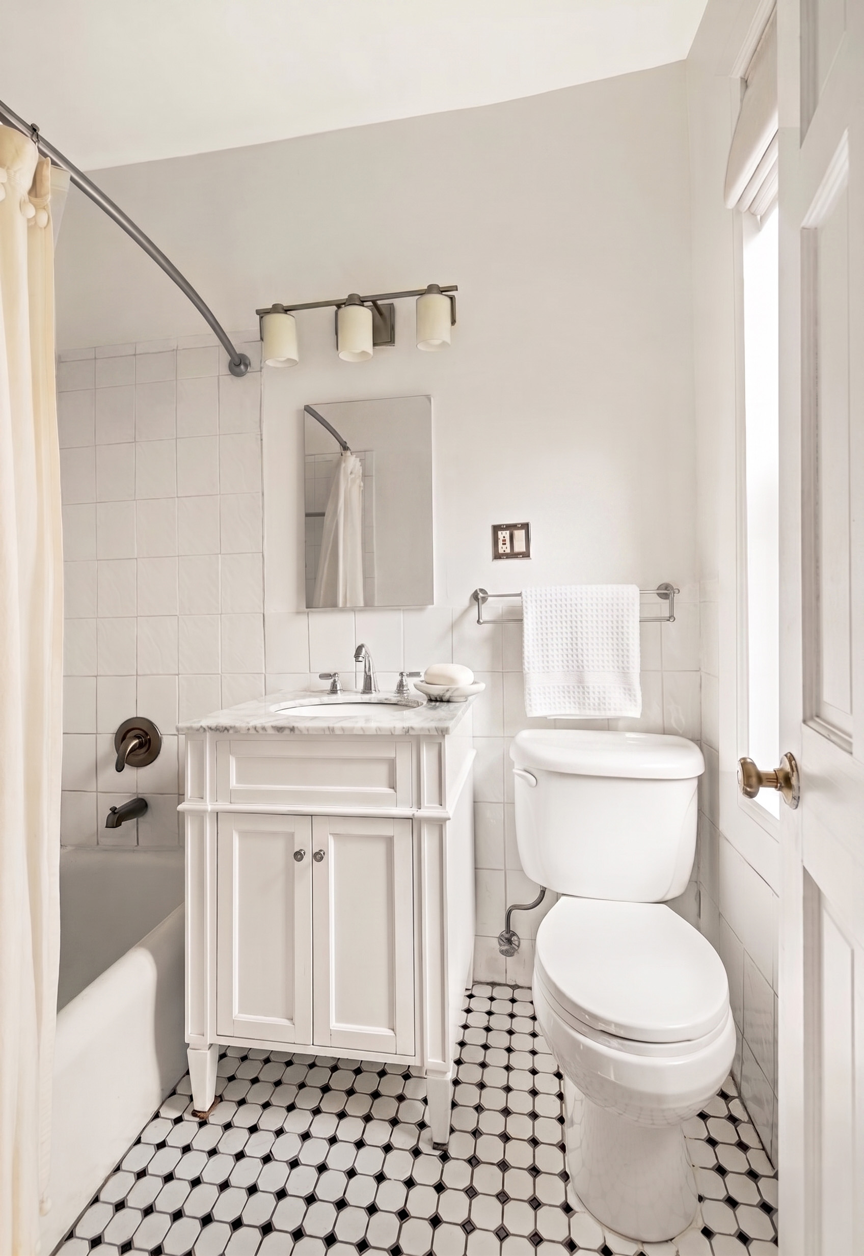 400 Lincoln Place, Unit 2B Brooklyn, NY 11238 - Photo 5 of 10 a bathroom with a sink toilet and shower