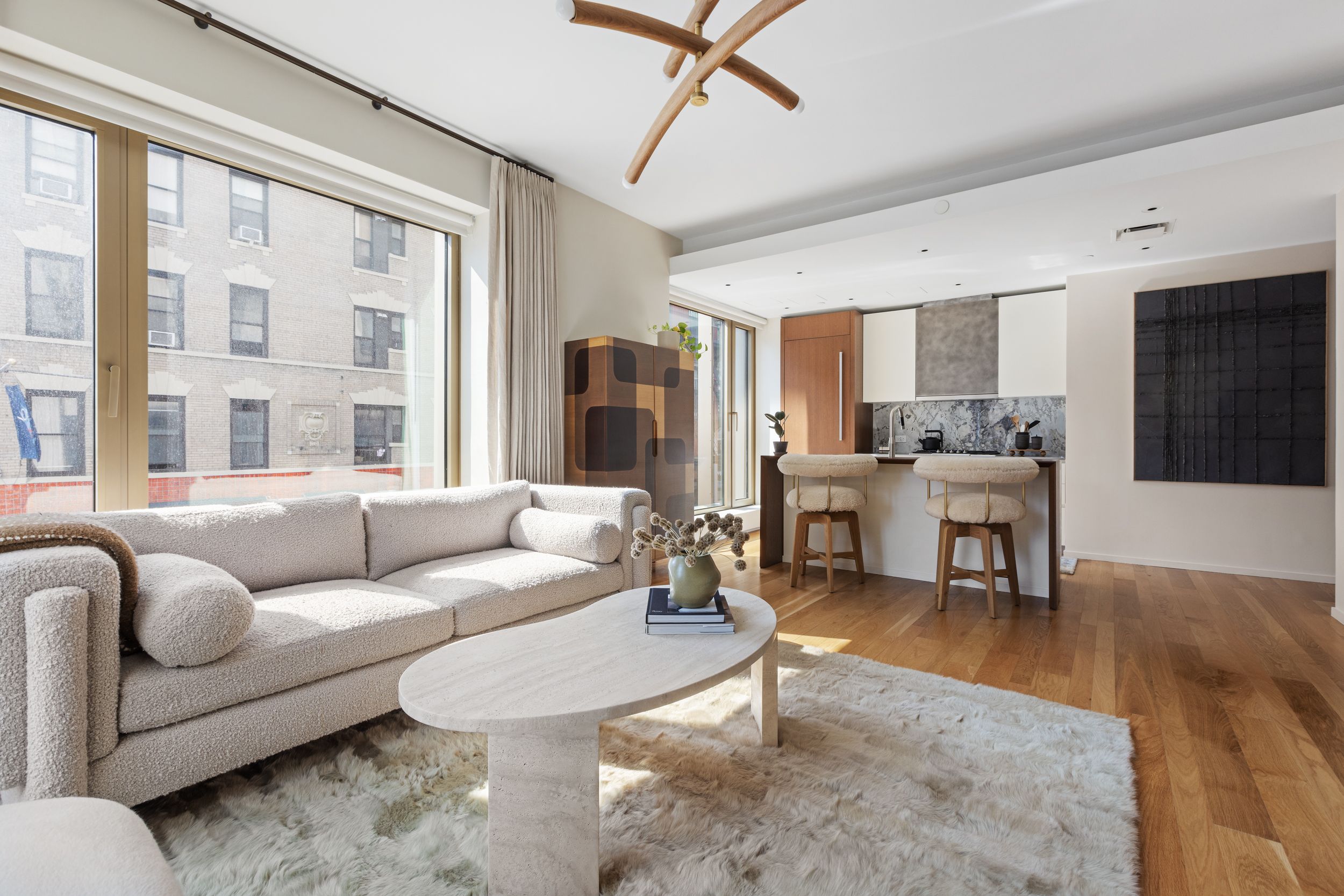 75 Kenmare Street, Unit 2D Manhattan, NY 10012 - Photo 2 of 15 a living room with furniture and a large window