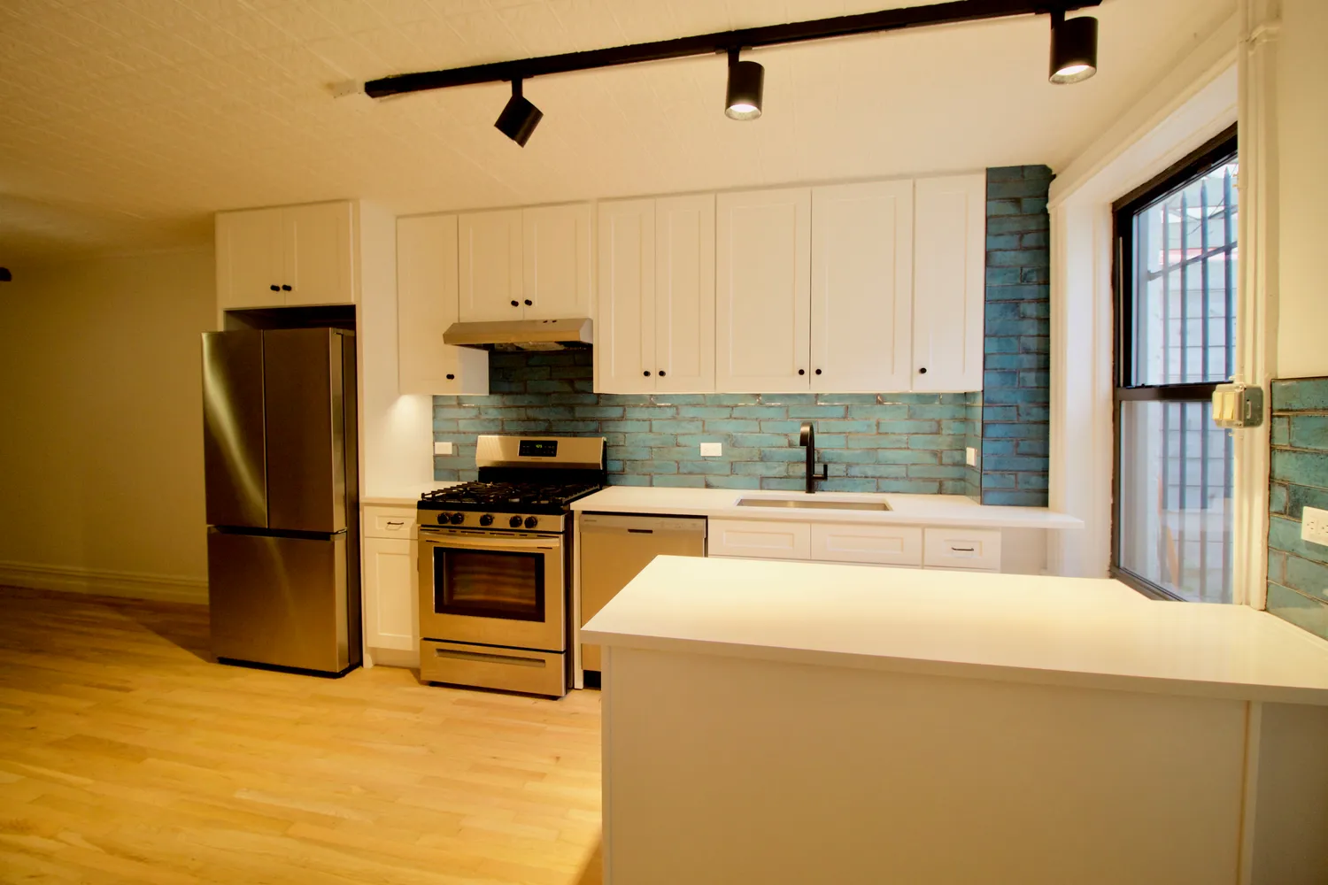 a bedroom with a bed dresser and a large window