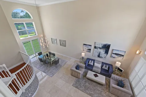 a living room with furniture and a potted plant