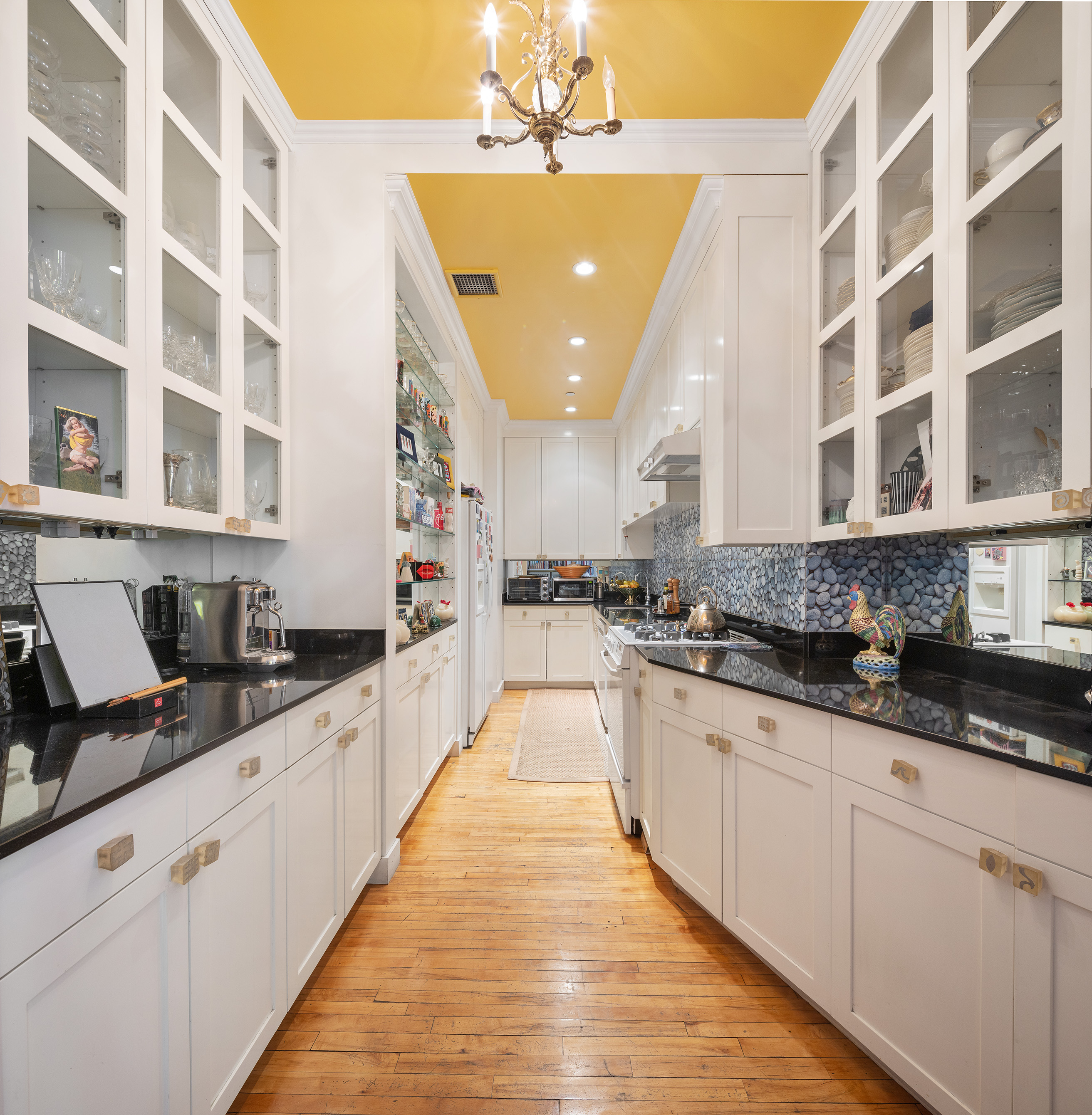 59 Wooster Street, Unit 3E Manhattan, NY 10012 - Photo 6 of 12 a large kitchen with granite countertop a sink and cabinets
