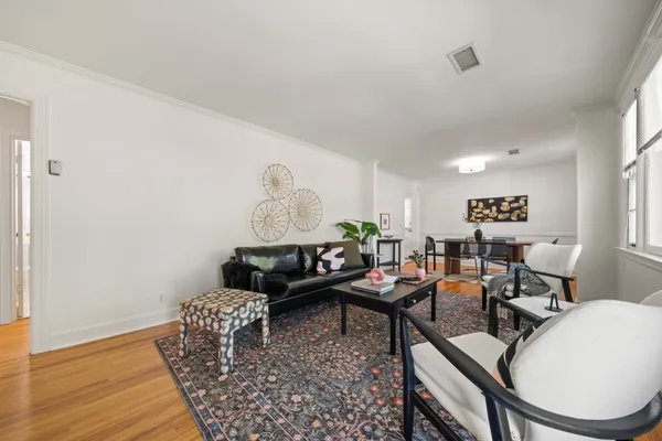 a living room with furniture and wooden floor