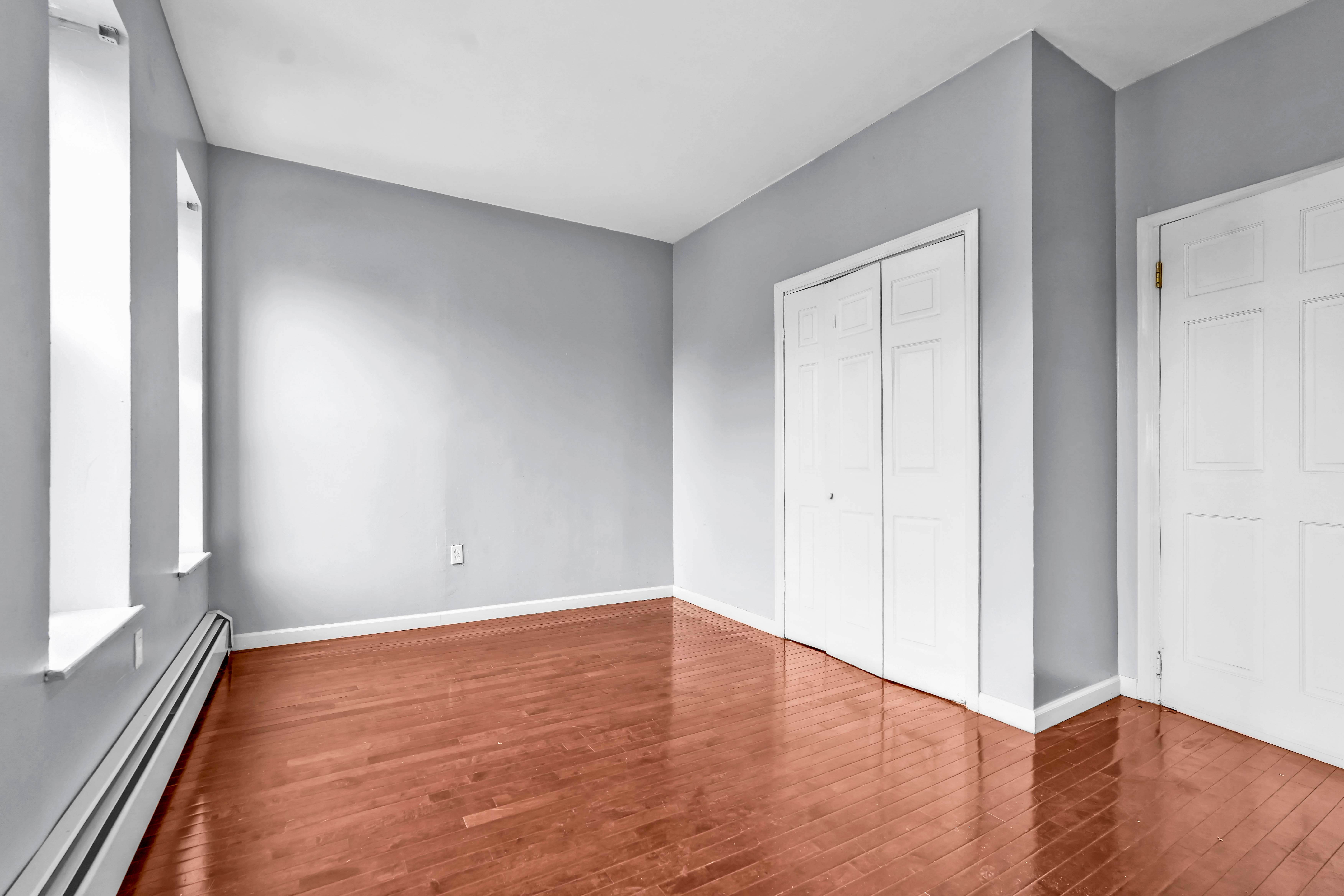 1633 St Johns Place, Unit 3 Brooklyn, NY 11233 - Photo 14 of 29 a view of an empty room with wooden floor and a window