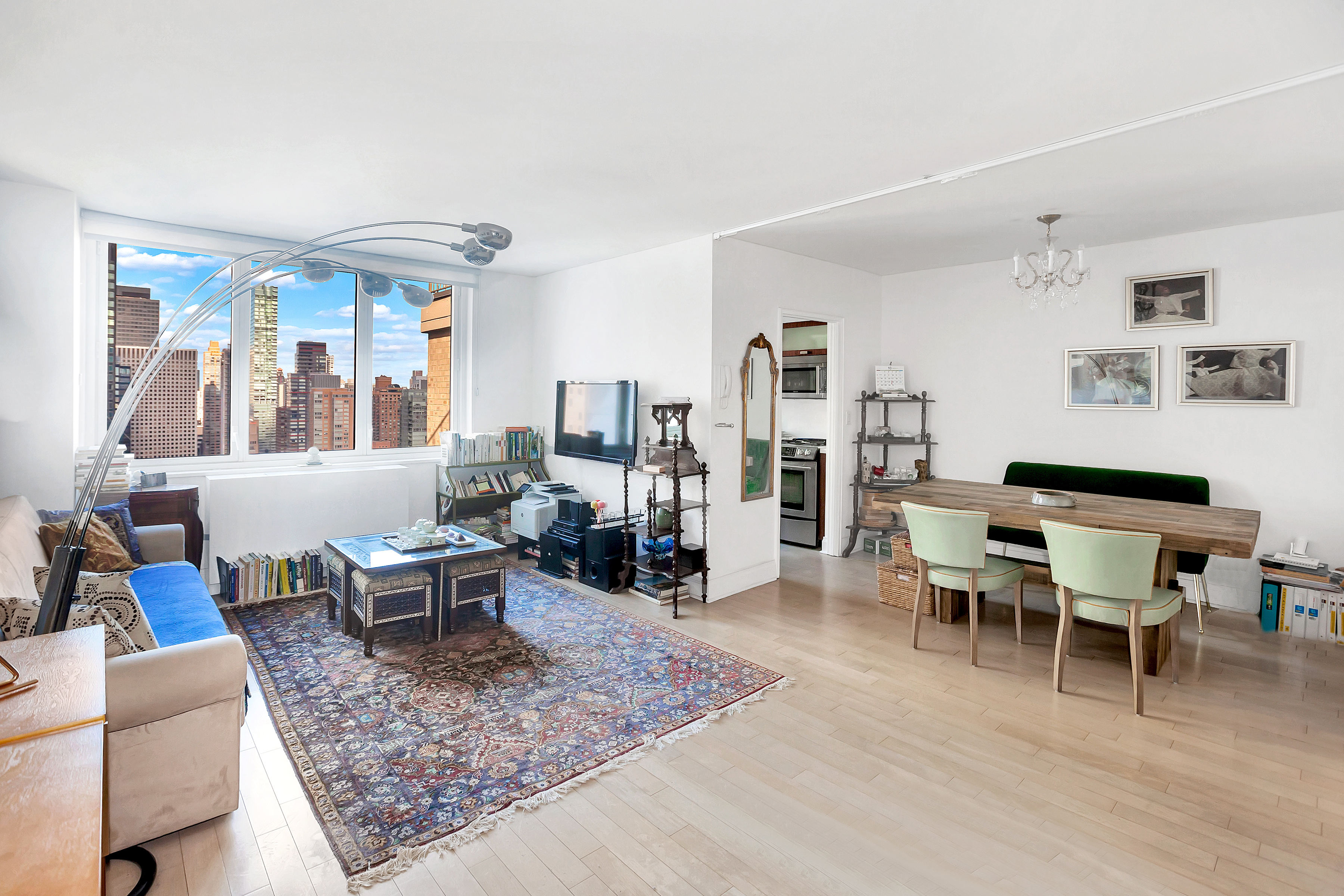 212 East 47th Street, Unit PHB Manhattan, NY 10017 - Photo 1 of 6 a living room with furniture a rug and a large window