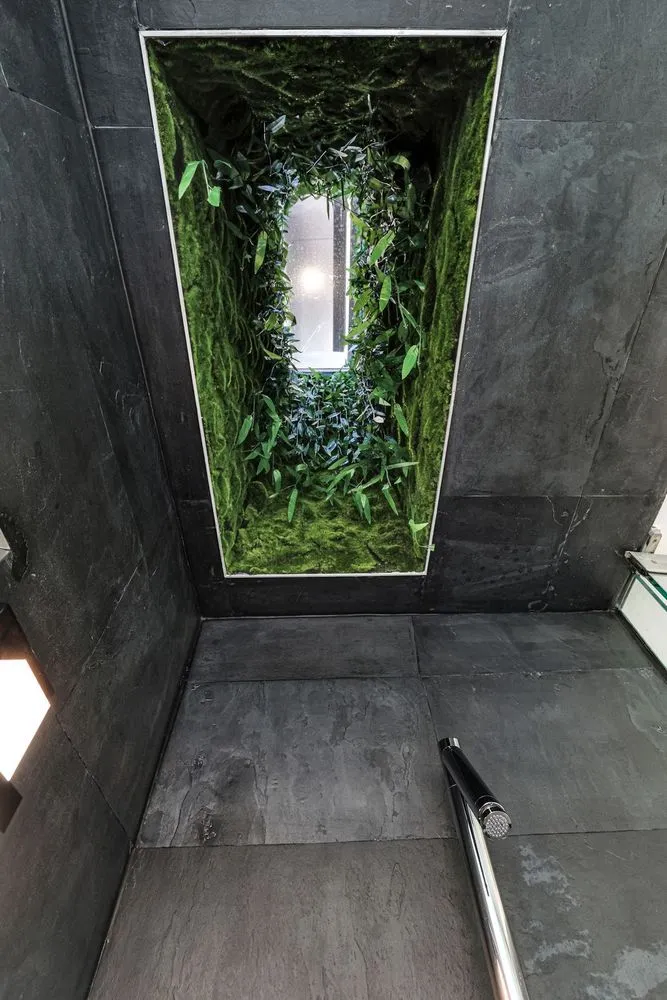 a bathroom with a glass shower door and a sink