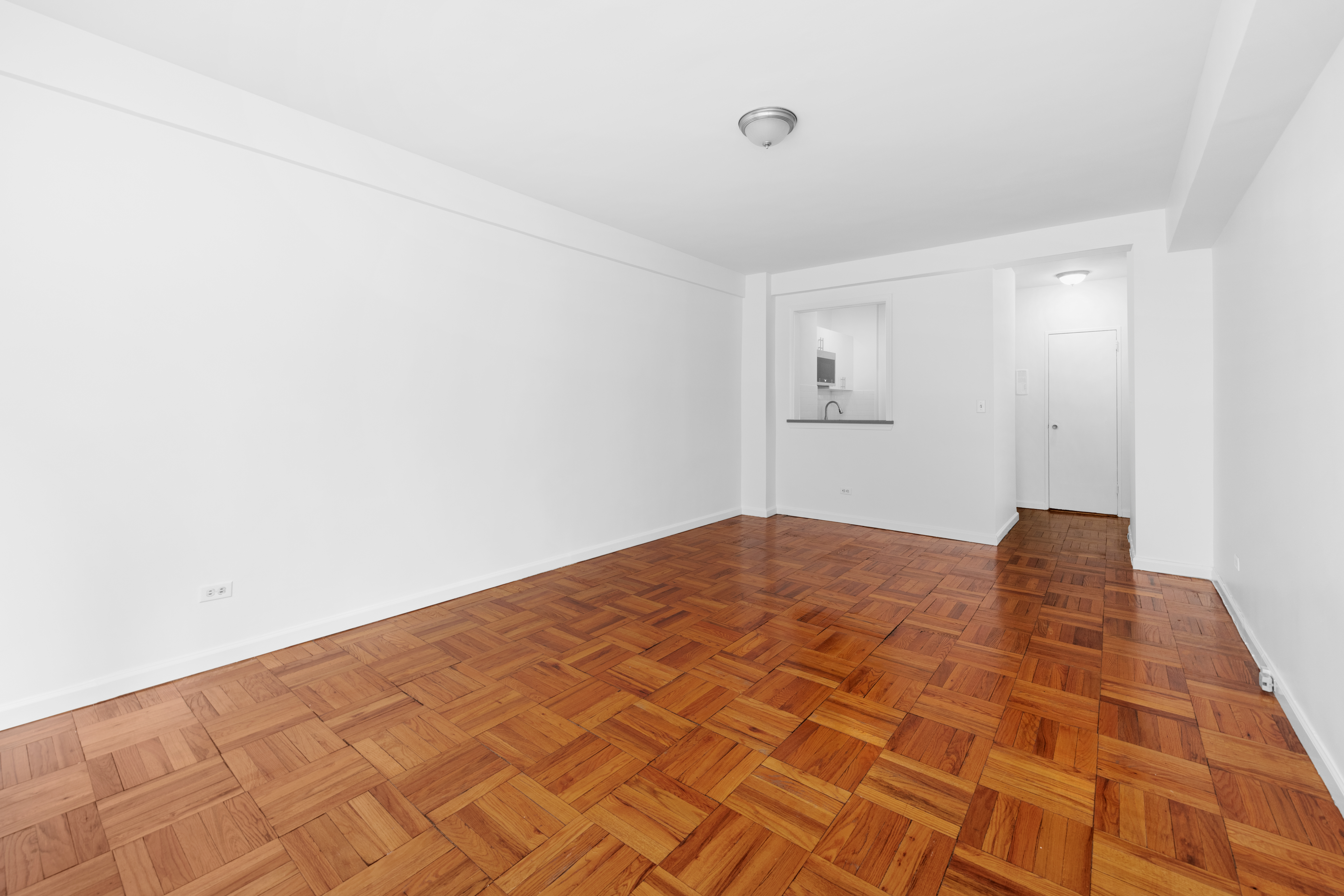 240 East 46th Street, Unit 8H Manhattan, NY 10017 - Photo 3 of 6 a big room with wooden floor
