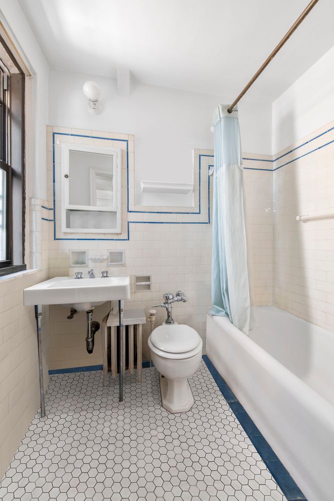 457 West 57th Street, Unit 1501 Manhattan, NY 10019 - Photo 5 of 6 a bathroom with a sink a toilet and shower