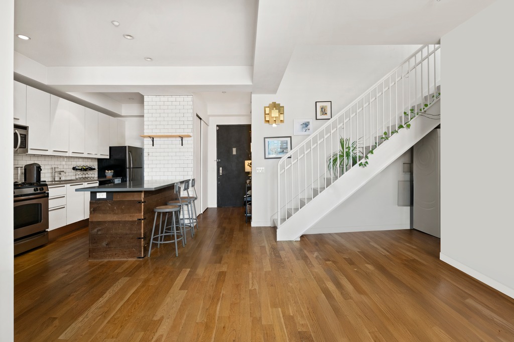 122 West Street, Unit PHA Brooklyn, NY 11222 - Photo 3 of 14 a view of kitchen and dining room with wooden floor