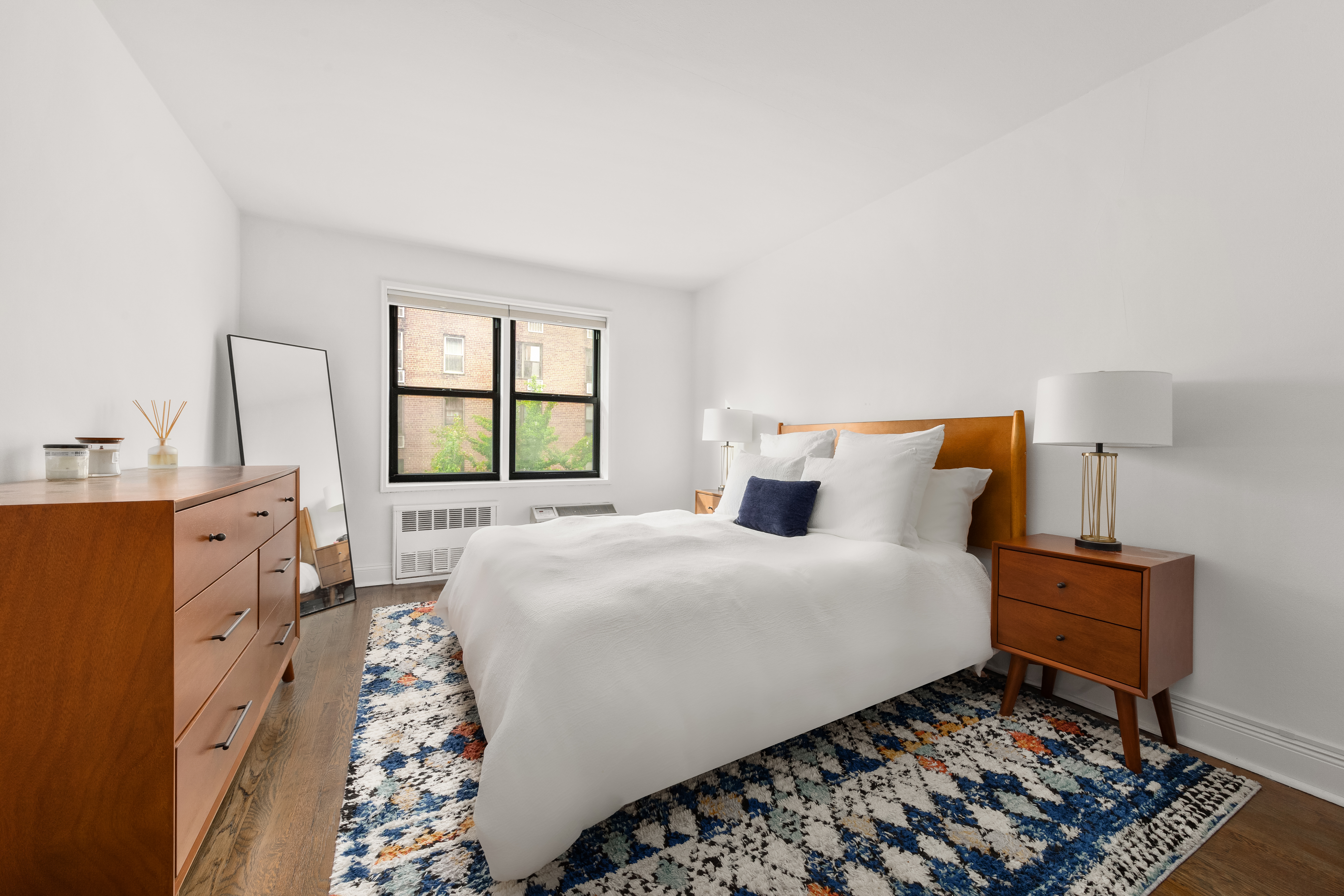 140 7th Avenue, Unit 4M Manhattan, NY 10011 - Photo 3 of 7 a bedroom with a bed and wooden floor