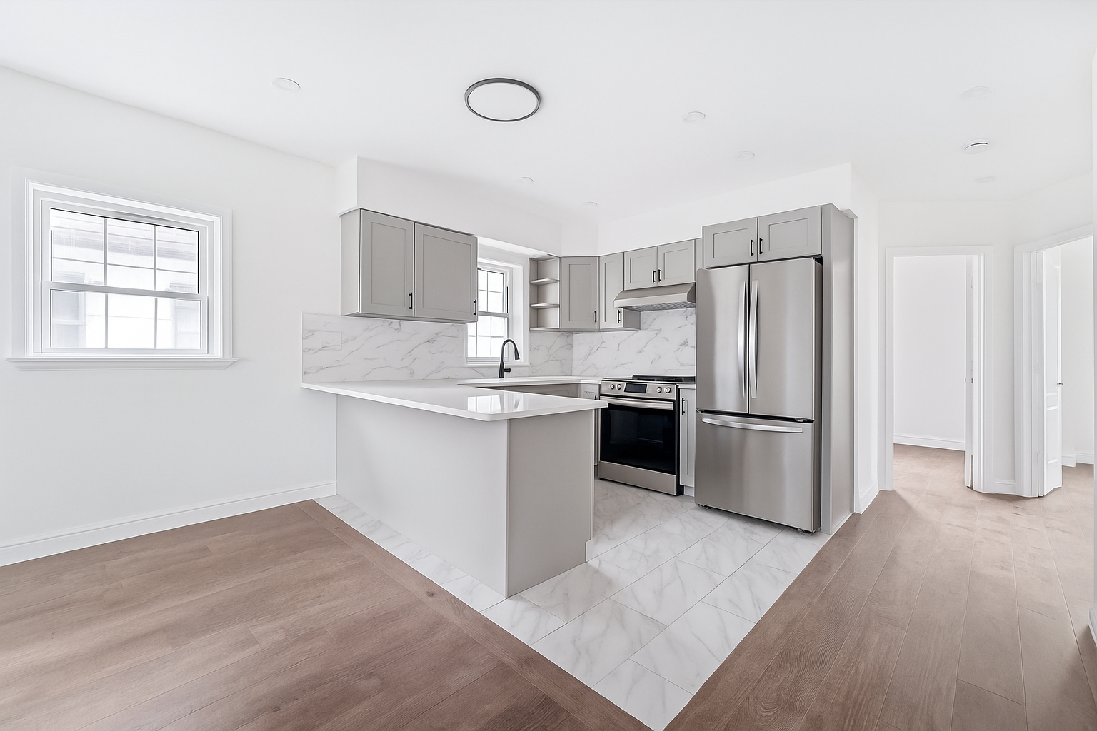 65 Bay 23rd Street, Unit 2 Brooklyn, NY 11214 - Photo 5 of 16 a kitchen with white cabinets and stainless steel appliances
