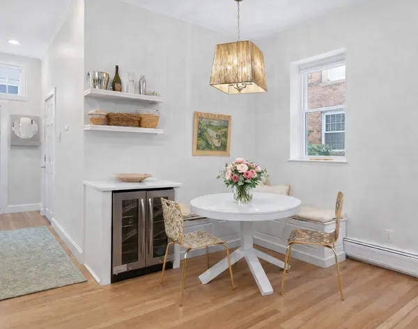 a view of a dining room with furniture wooden floor and a chandelier