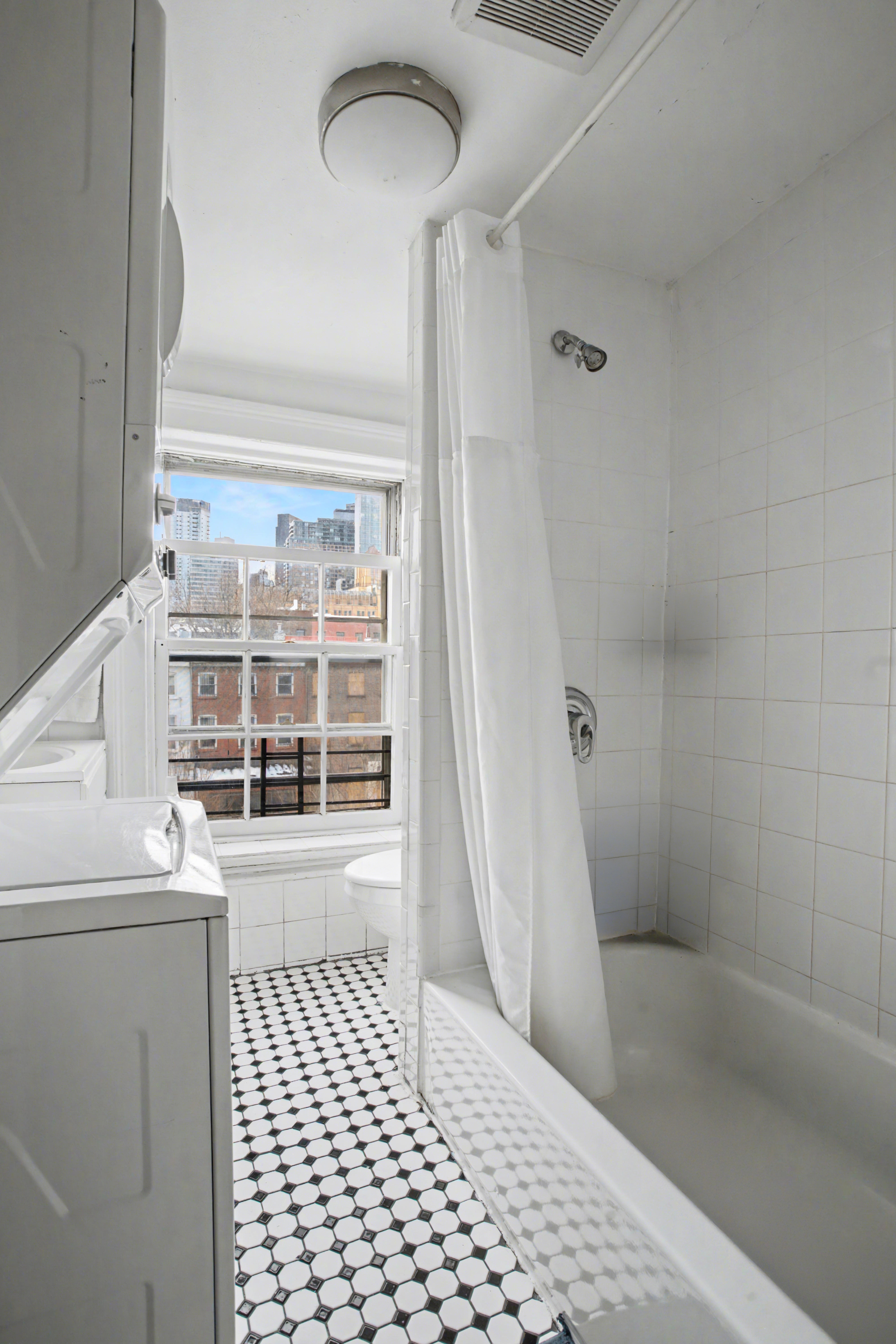 246 Cumberland Street, Unit 2 Brooklyn, NY 11205 - Photo 14 of 15 a bathroom with a sink a toilet a window and shower