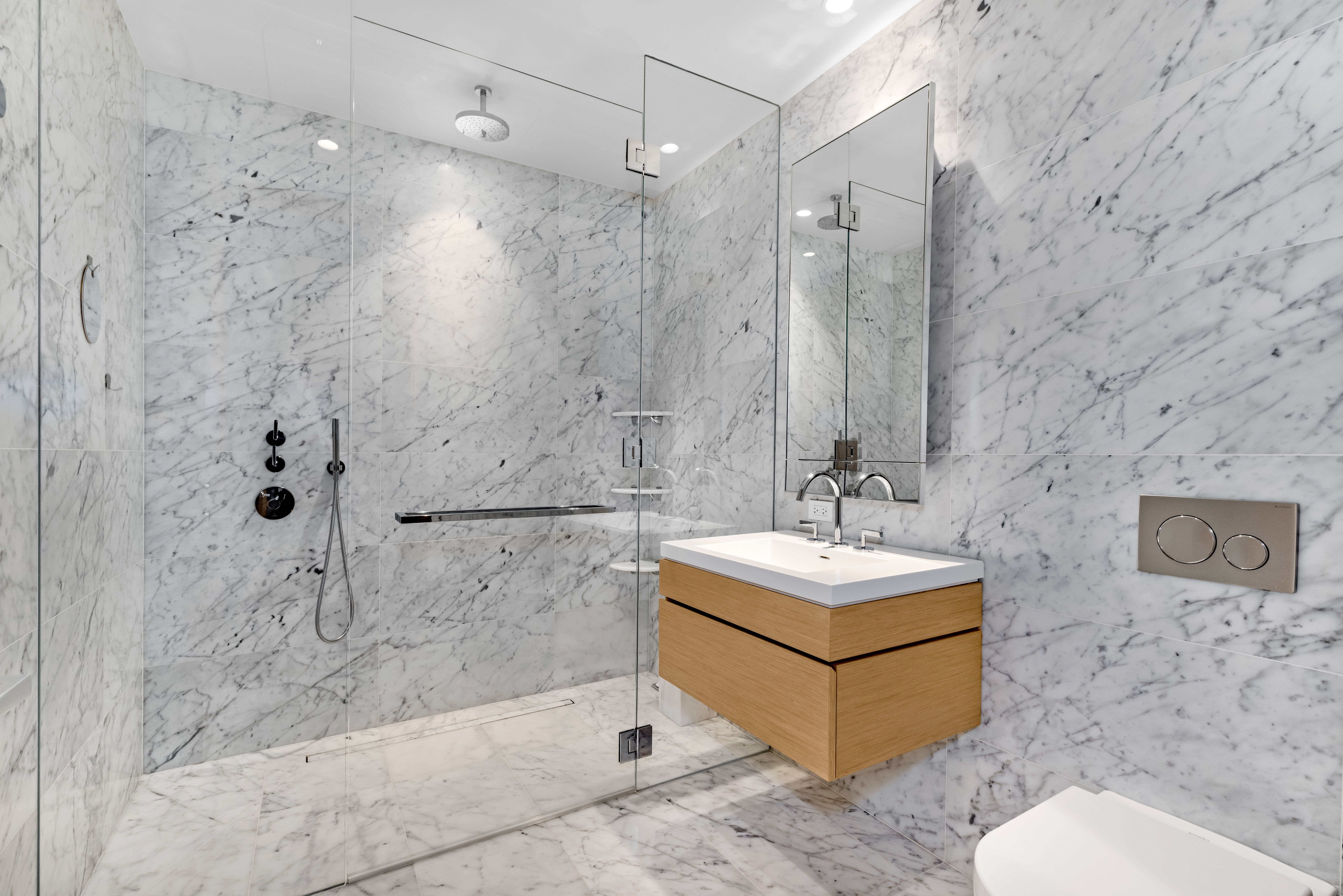 565 Broome Street, Unit N11D Manhattan, NY 10013 - Photo 6 of 18 a bathroom with a sink mirror toilet and shower