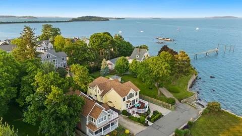 an aerial view of a house with a lake view