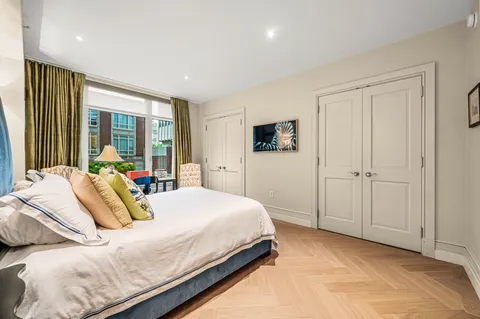 a bedroom with a large bed and a large window