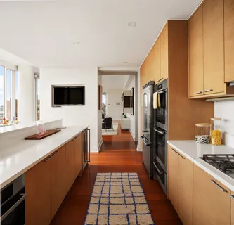 a kitchen with stainless steel appliances a stove a sink and a refrigerator