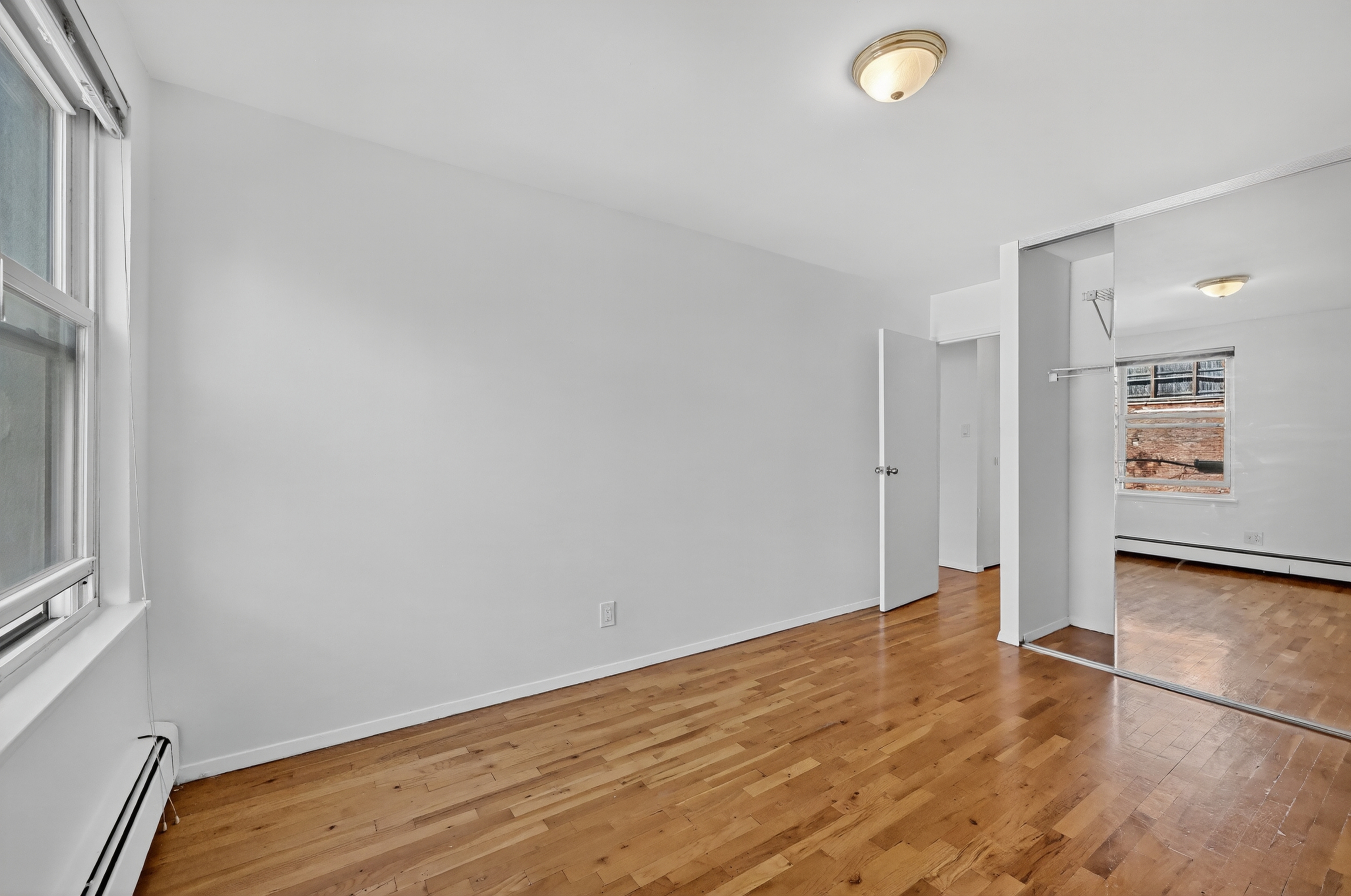 81 President Street, Unit 51-A Brooklyn, NY 11231 - Photo 25 of 27 wooden floor in an empty room with a window