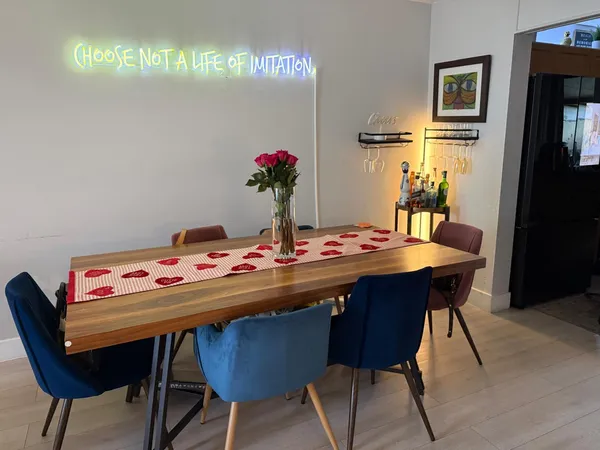 a view of a dining room with furniture and wooden floor