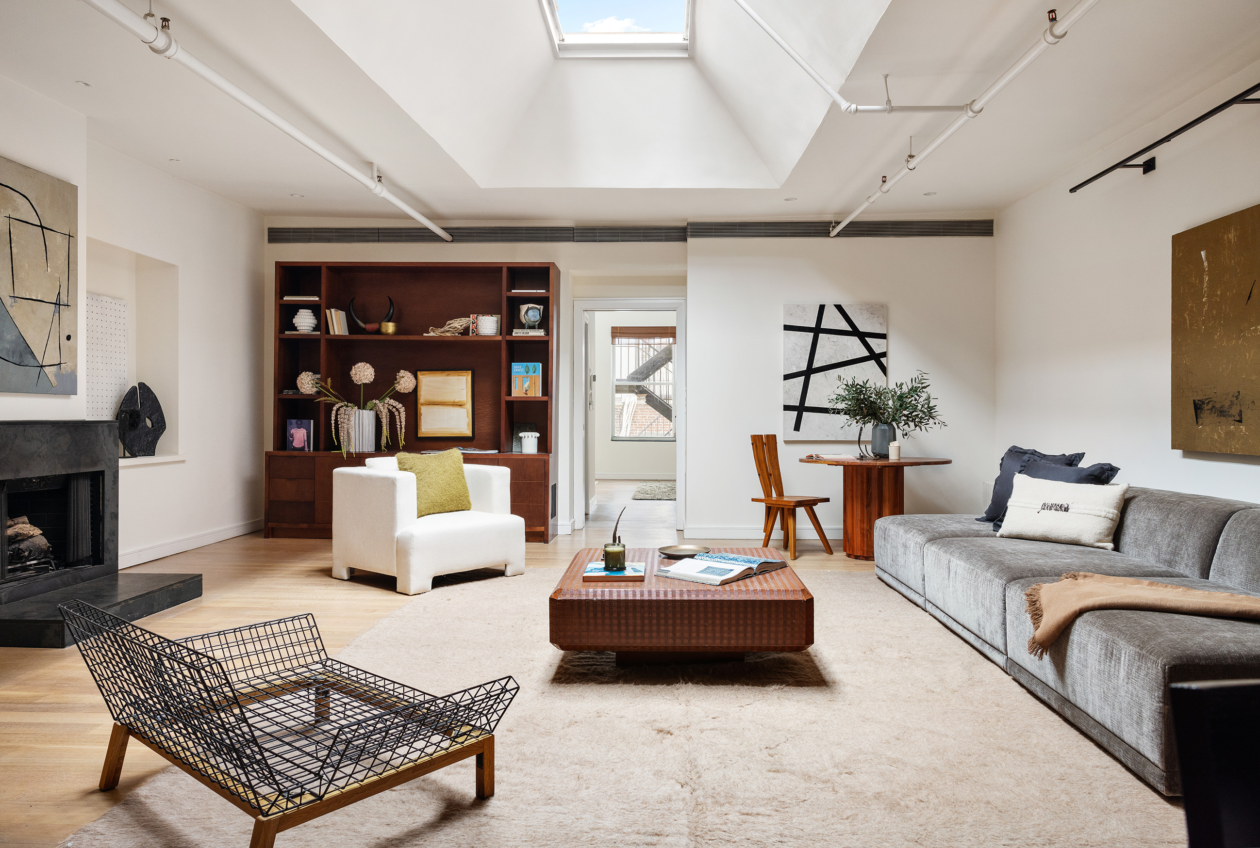 169 Mercer Street, Unit PH Manhattan, NY 10012 - Photo 2 of 15 a living room with furniture and wooden floor
