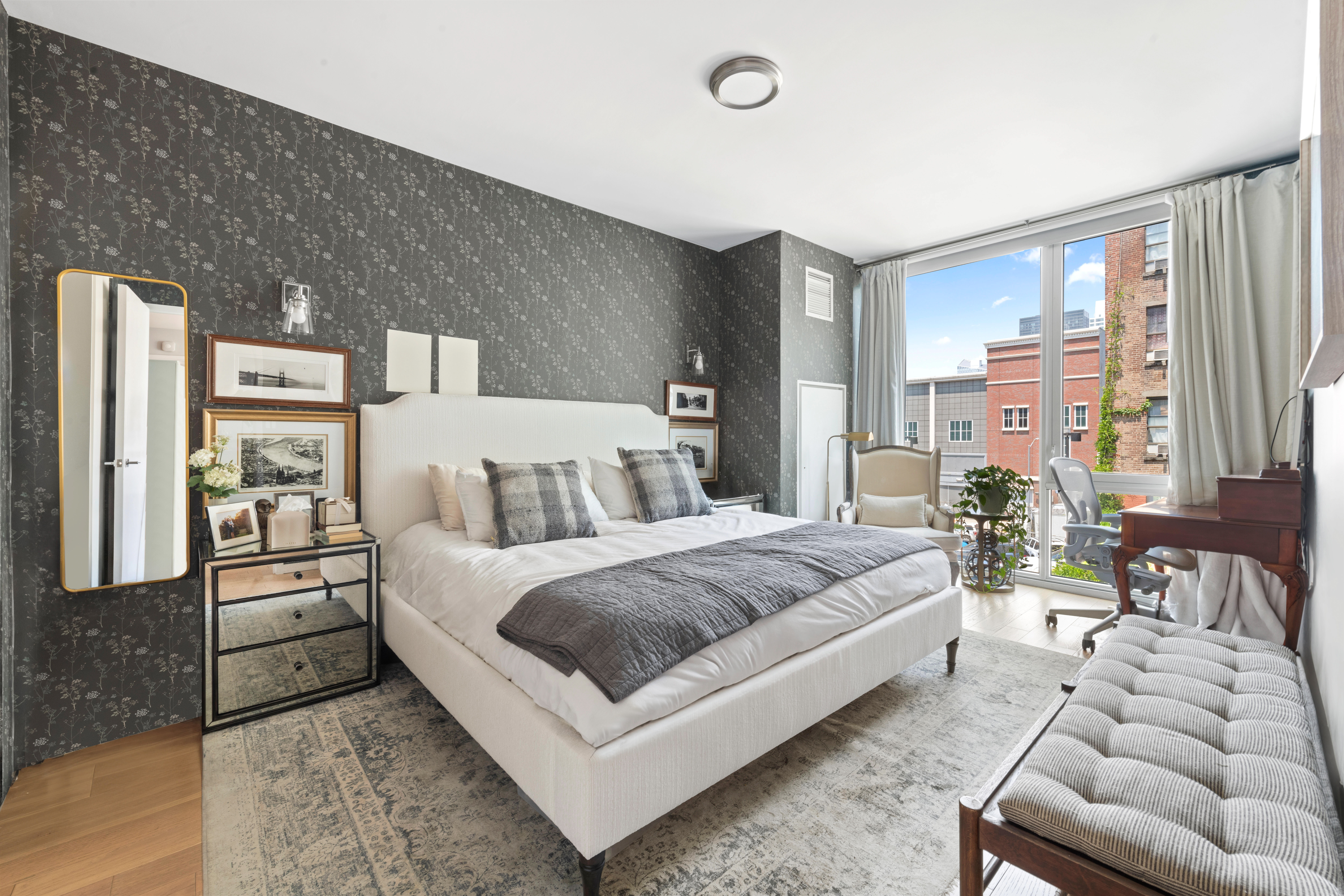 540 West 49th Street, Unit 401S Manhattan, NY 10019 - Photo 6 of 14 a spacious bedroom with a bed and a couch