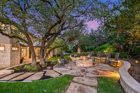 a view of house with backyard and outdoor seating